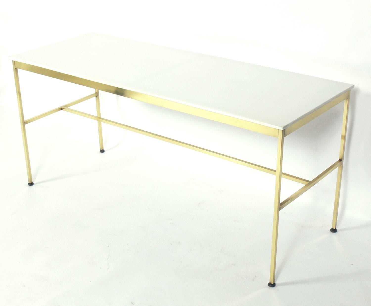 Modernist brass and milk glass console, designed by Paul McCobb, American, circa 1950s. This piece is a versatile size and can be used as a console table, sofa table, or bar. The brass has been hand polished and lacquered.