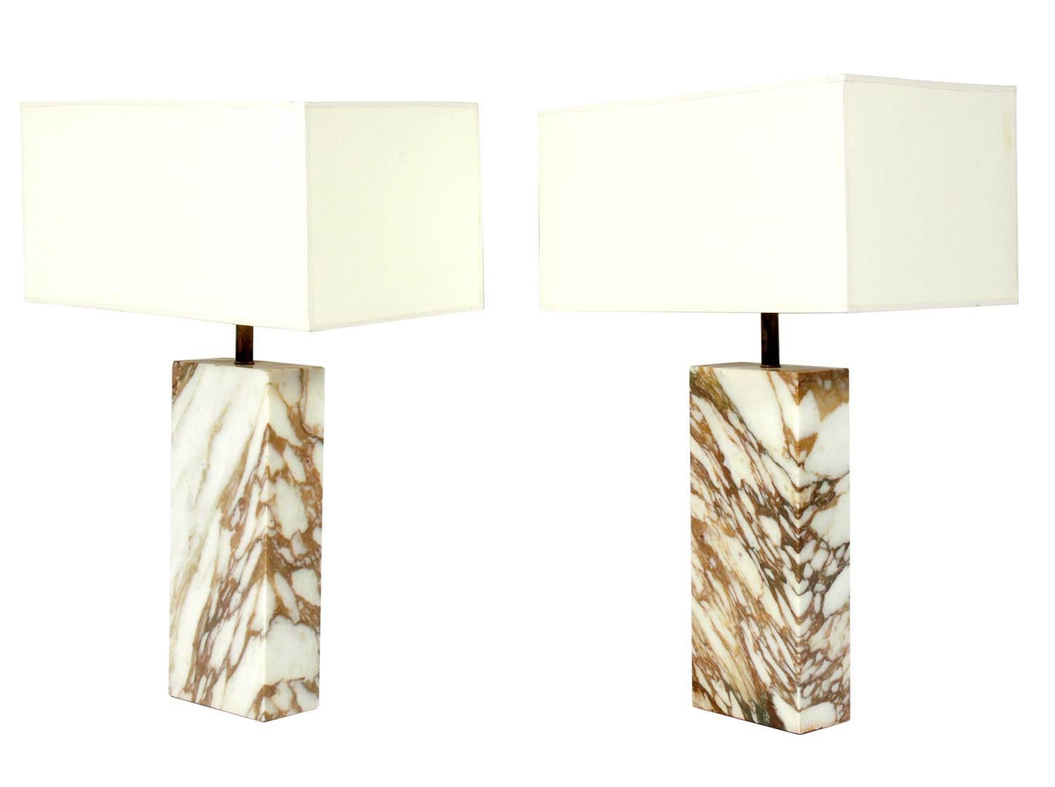 Pair of clean lined marble slab lamps, American, circa 1960s. They exhibit beautiful tan-caramel color graining in the ivory color marble slabs. Rewired and ready to use.
