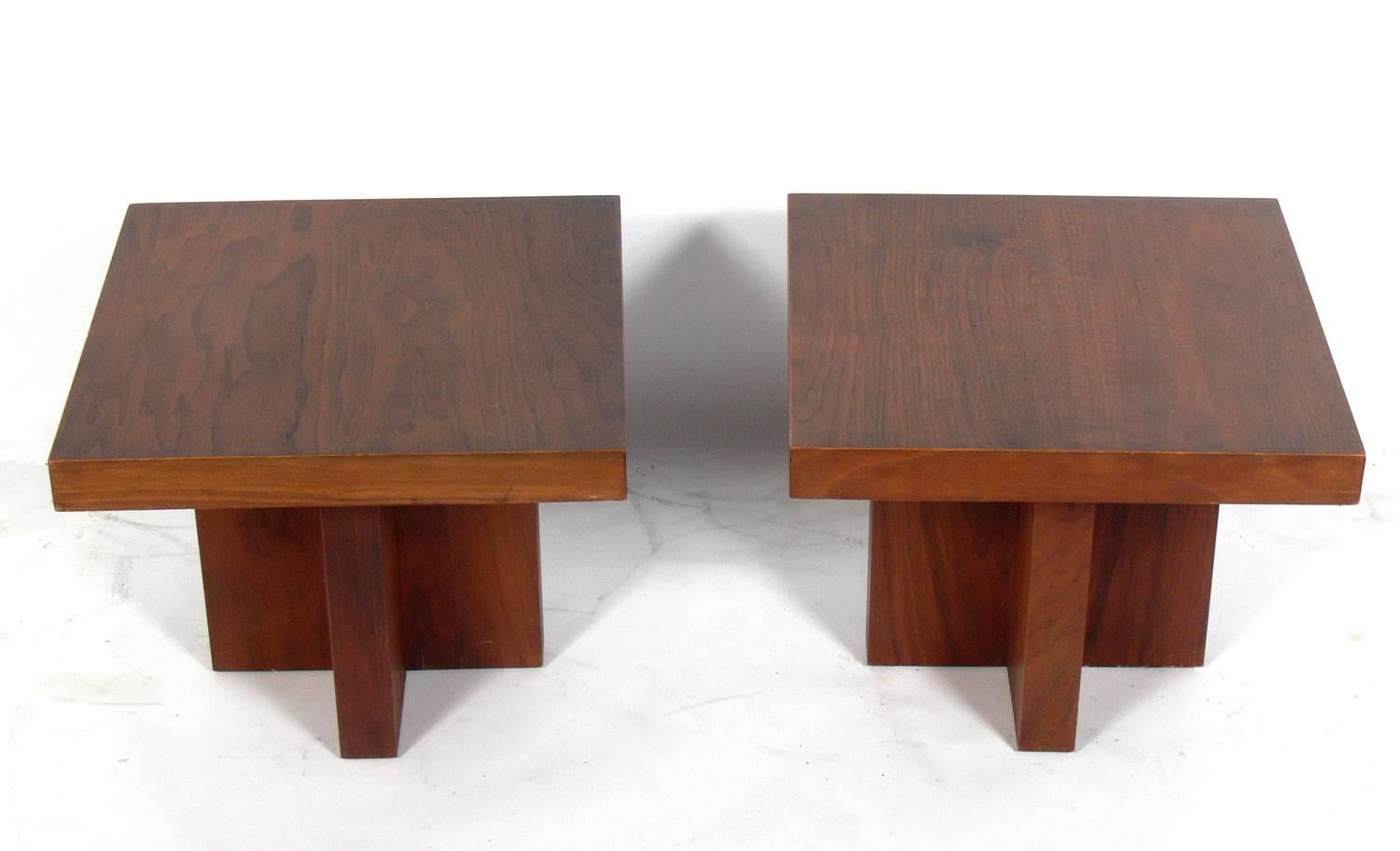 Pair of clean lined walnut end tables, designed by Milo Baughman for Thayer Coggin, American, circa 1960s. These tables have a clean lined architectural design and can be used as end or side tables, night stands, or pushed together to be used as a
