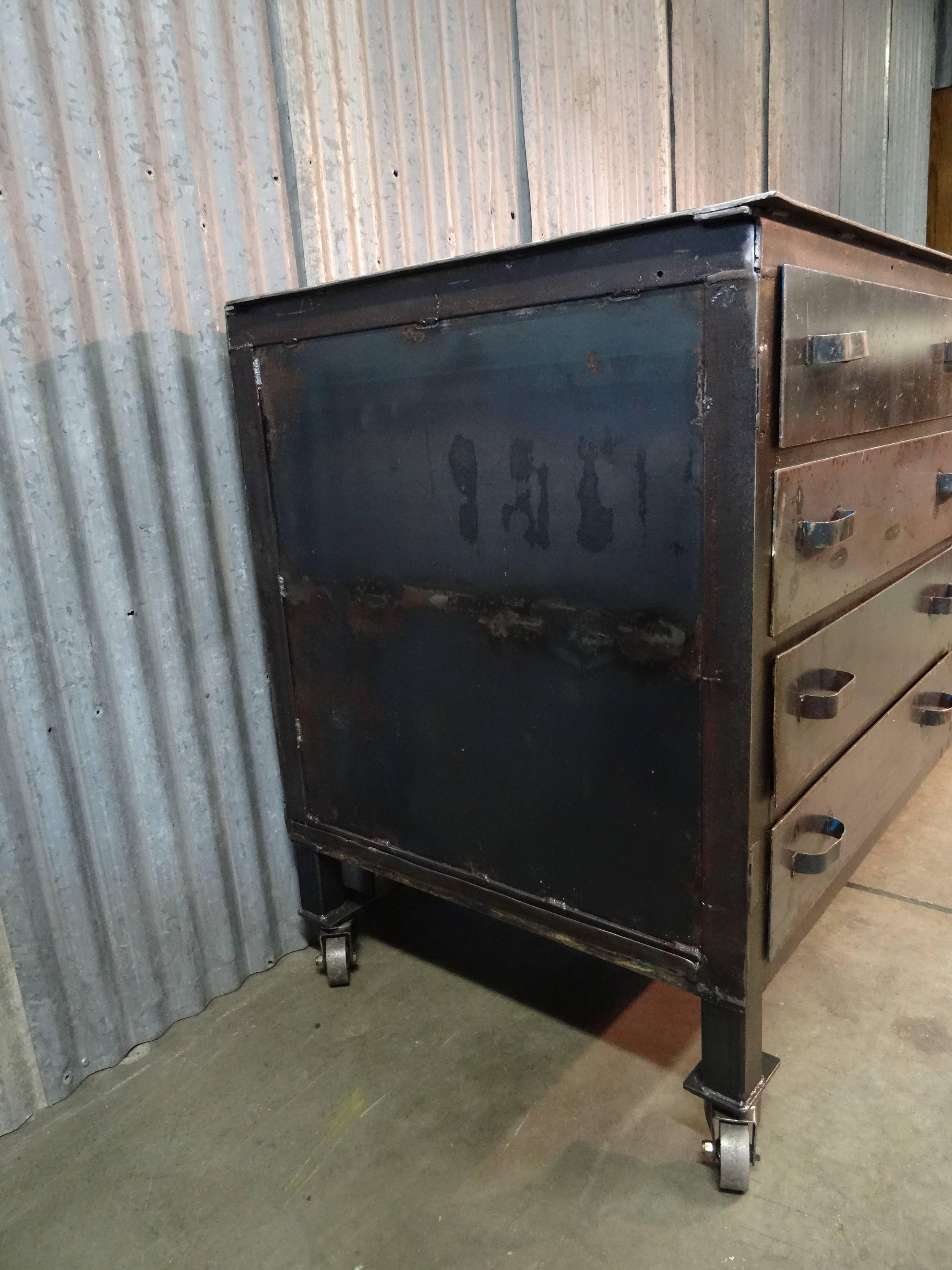 1930's steel work station found in an airplane mechanic's shop.  This piece is a show stopper!  Wonderfully crude, yet the dings, dents, and color inside the drawers is pure magic.  This beauty has 8 drawers, which slide with ease, and a two door