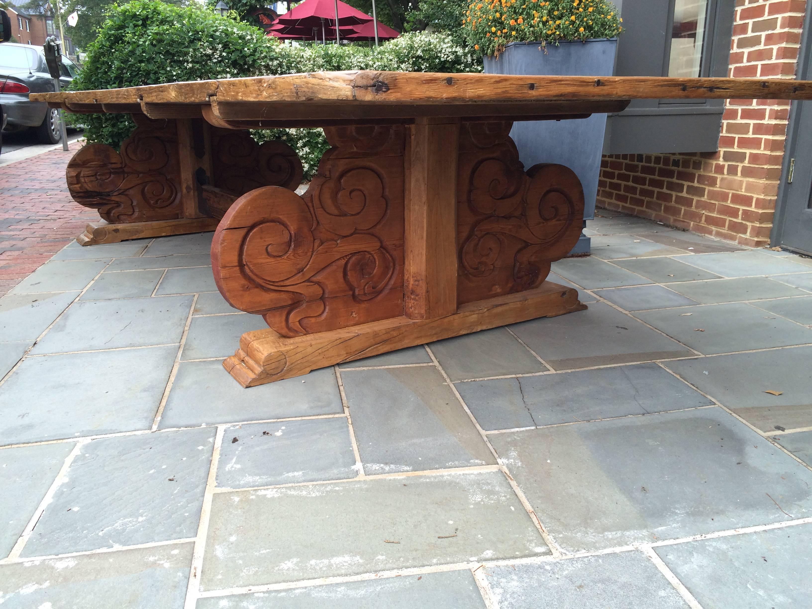 Magnificent  Early 19th Century Venetian Banquet Table. Rustic Charm with wonderful grande proportions . Made of richly patinated Pine with a lustrous honey color. The thick cleated top over a heavily carved oriental trestle base with a central