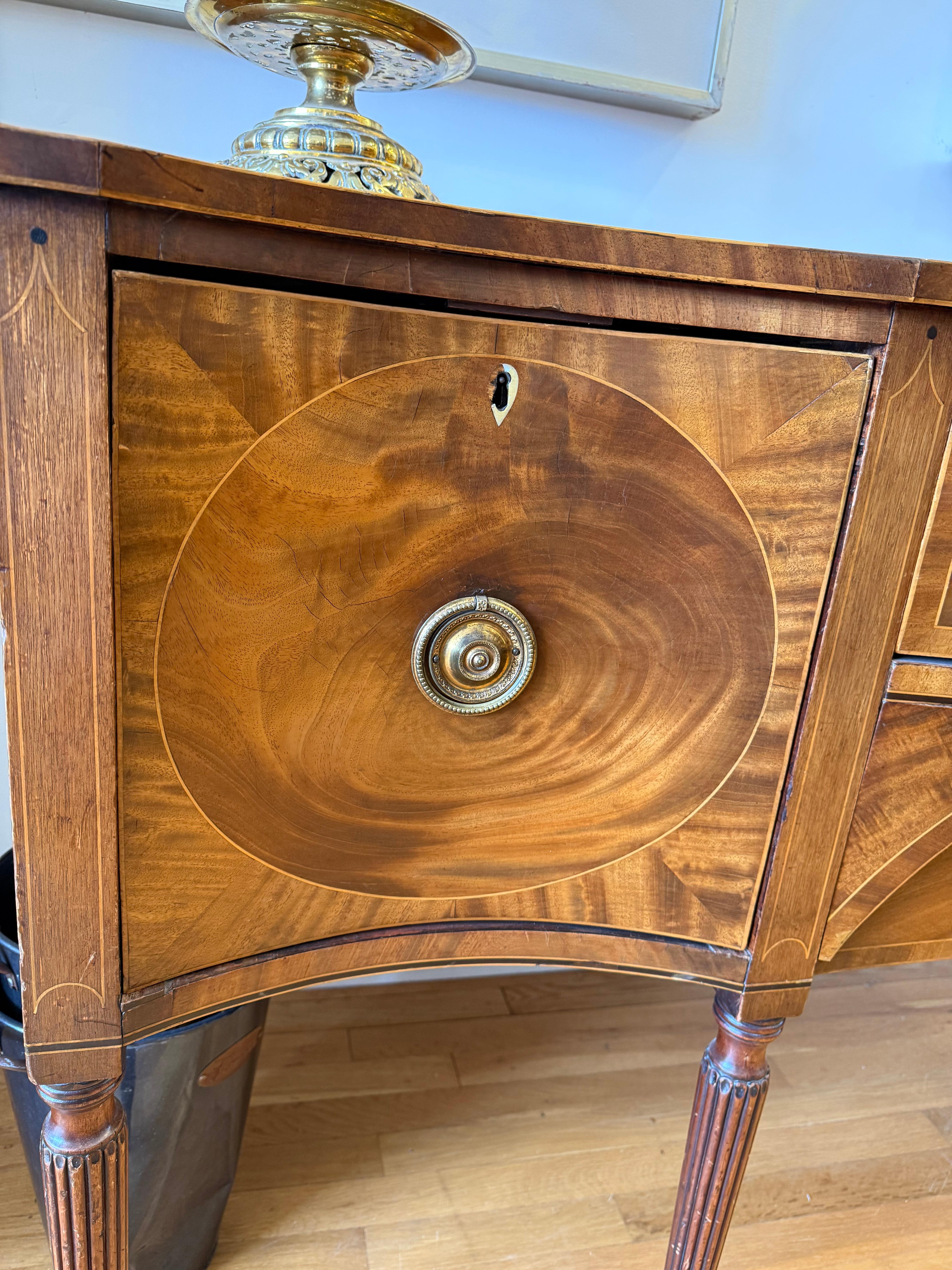 Carved Early Sheraton Period Flame Mahogany Serpentine Sideboard For Sale