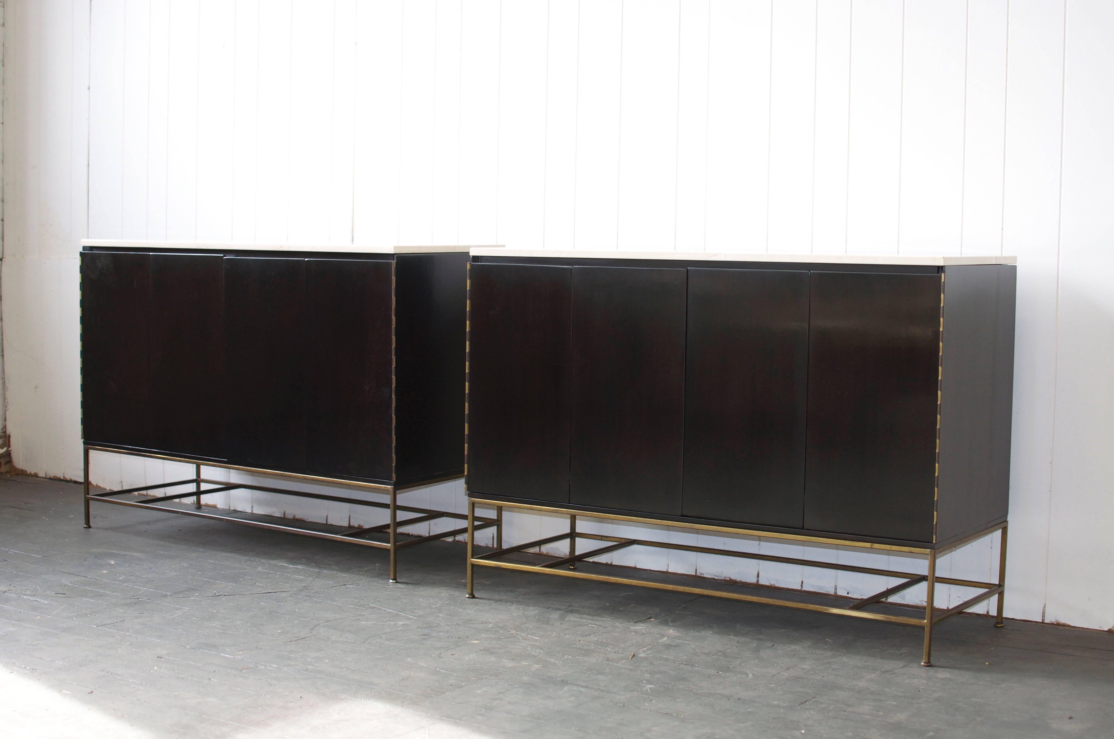 Pair of Paul McCobb dresser with marble tops for Calvin Group. Bi-fold doors conceal four drawers and shelf. Brass legs. 

Can be sold individually but listed and priced for the pair.
Please inquire for designer pricing.