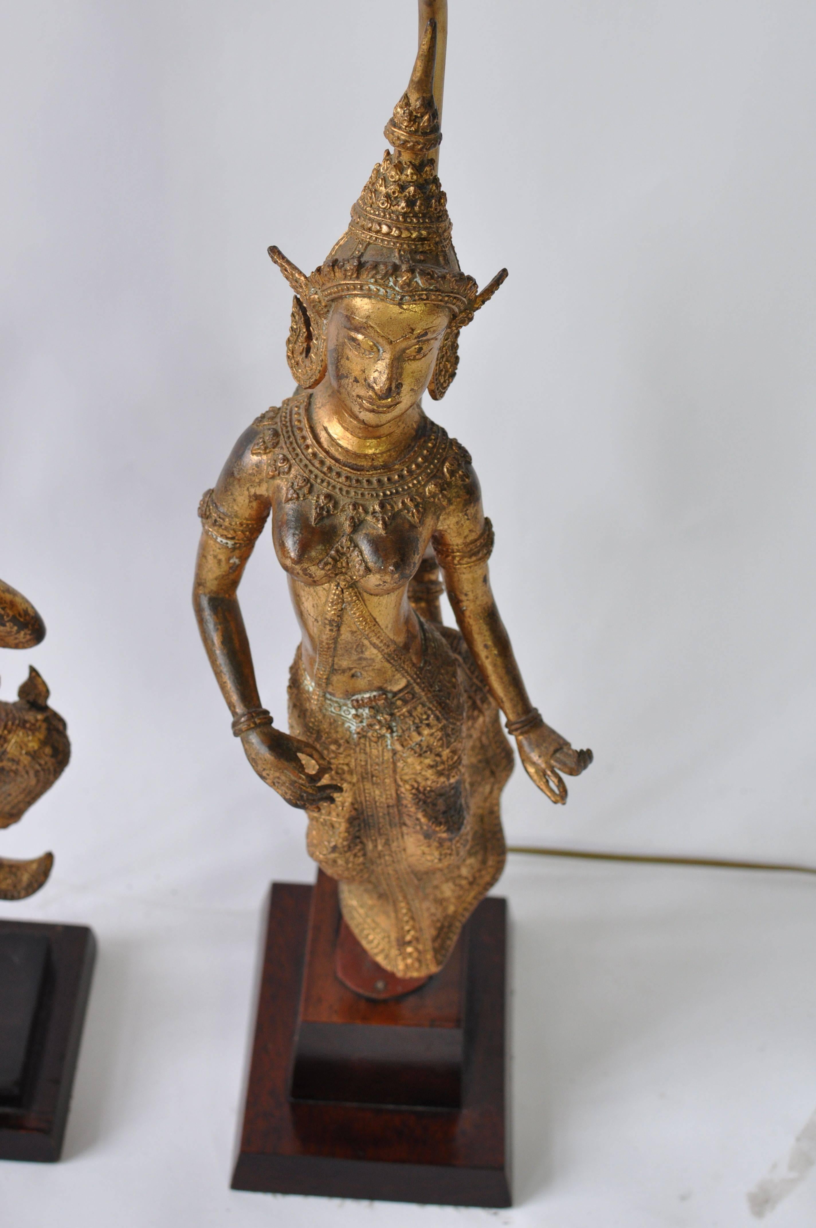 Collection of vintage Thai figure lamps. Gilt bronze over metal. Wood base. Priced as a collection or email for individual pricing.

Lamps measure from left to right.
35.5 tall X 6 W X 7.25 d.
23 tall X 6.75 wide X 6.25 deep.
33 tall X 12.5