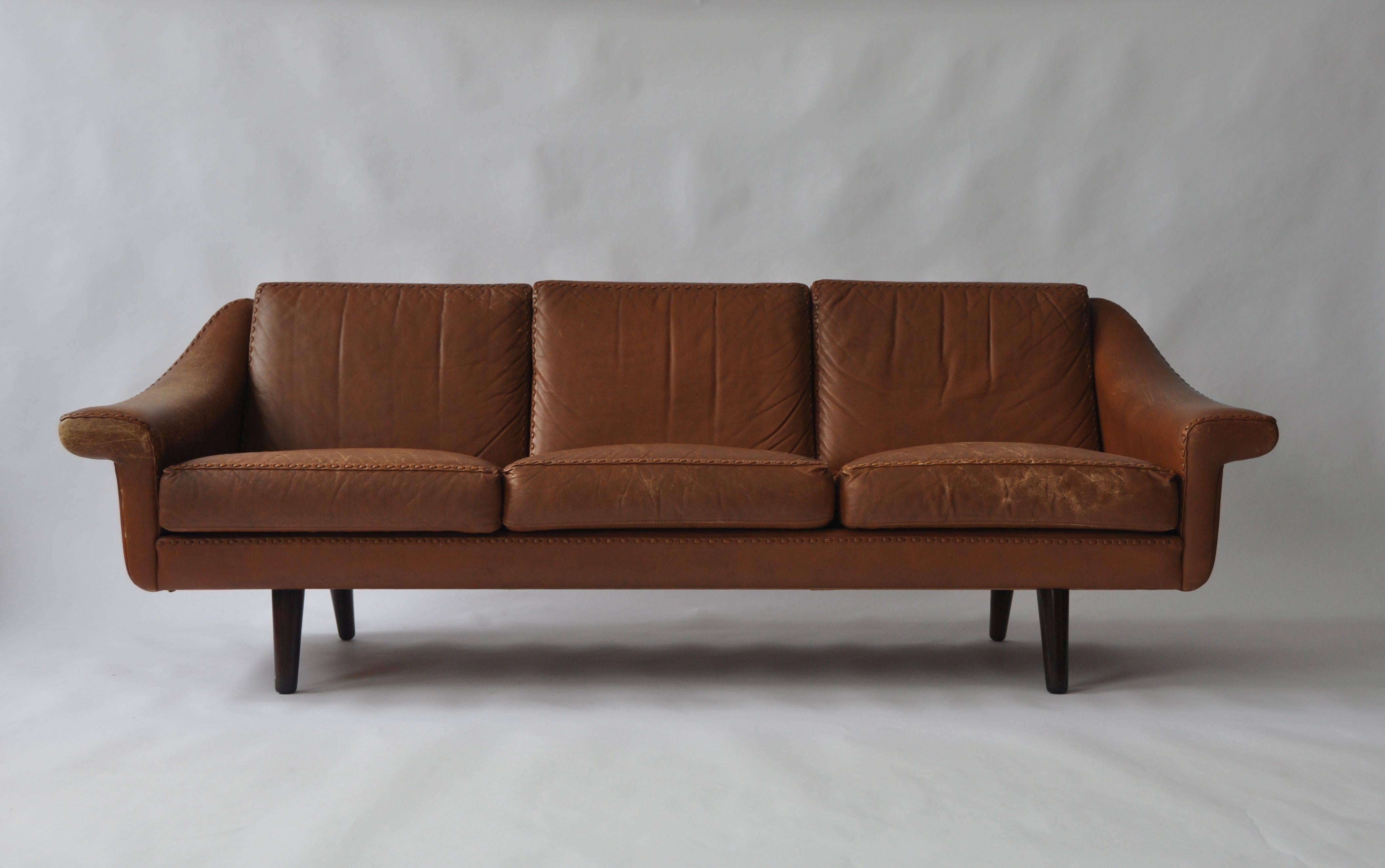 Aage Christiansen Danish leather sofa, 1960s. Teak legs.