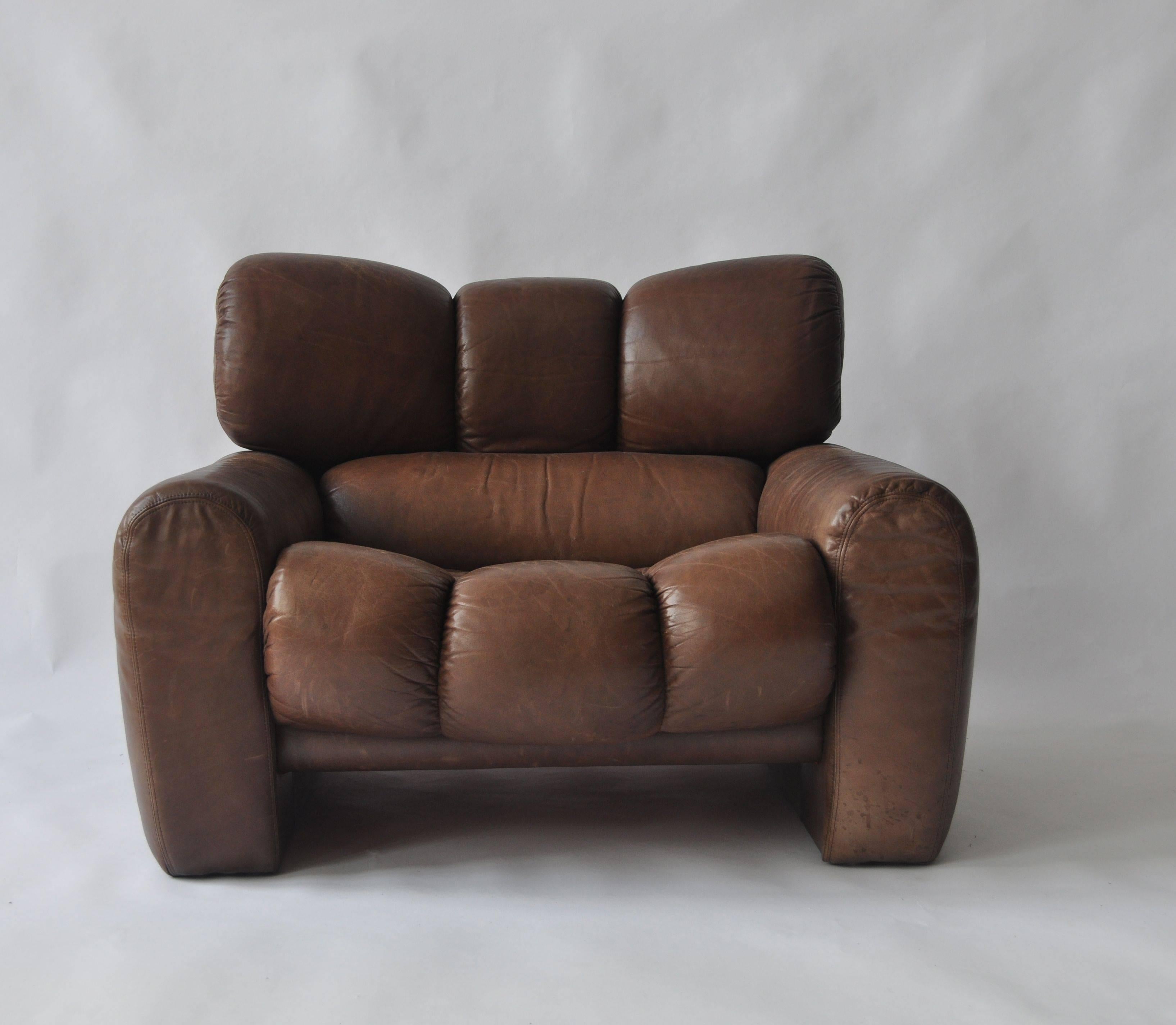 Large-scale 1970s leather lounge chair. Exceptional quality and comfort. Original leather is nicely worn with great patina.