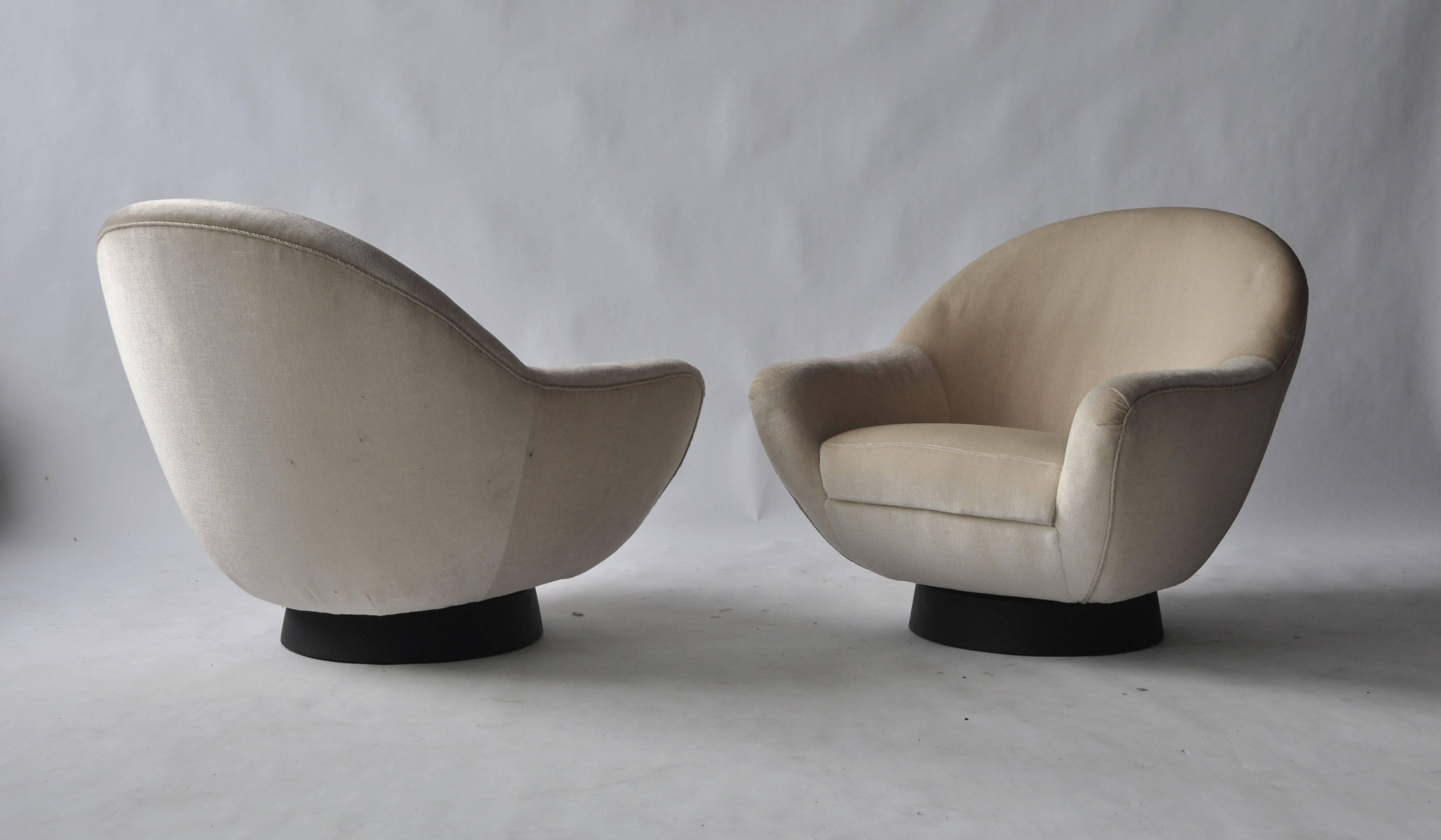 Pair of sculptural swivel lounge chairs by Hans Kaufeld. Faux leather wrapped base. Matching sofa available.