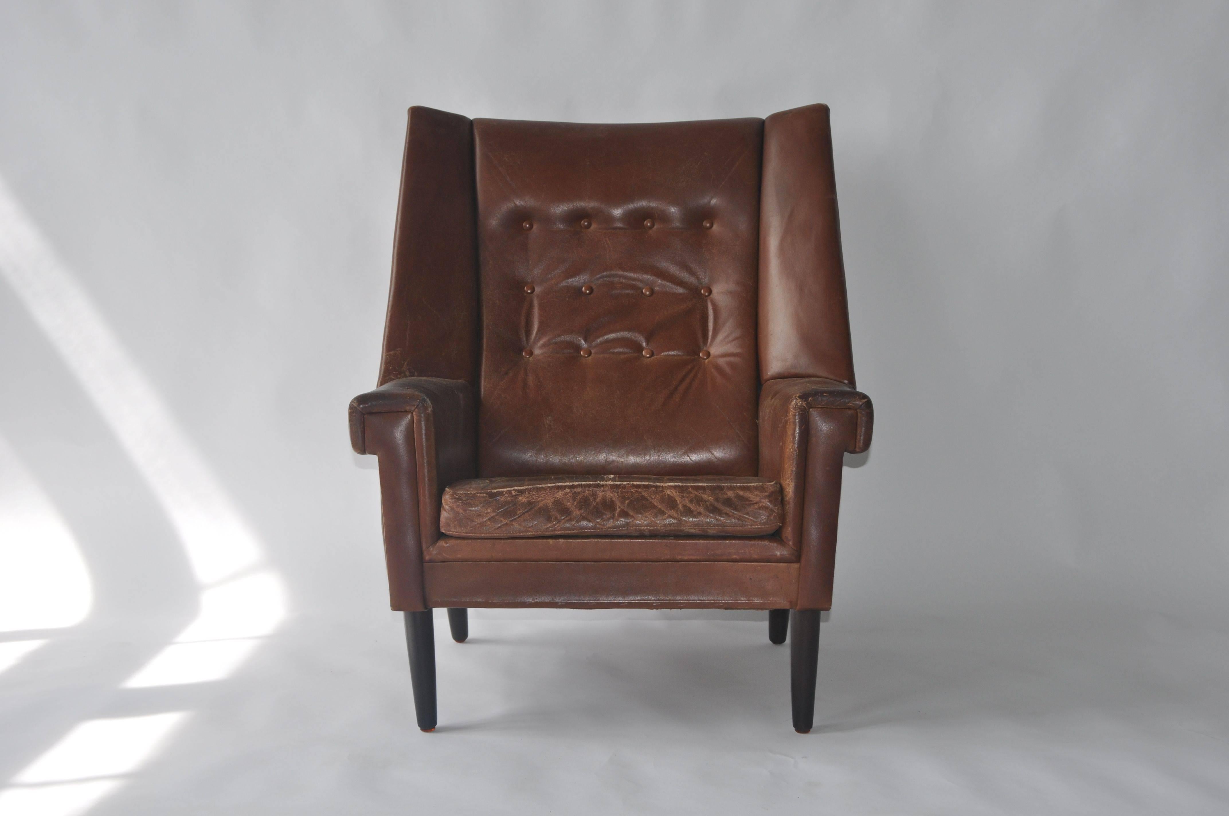 High Back Danish lounge chair. Original leather is worn.