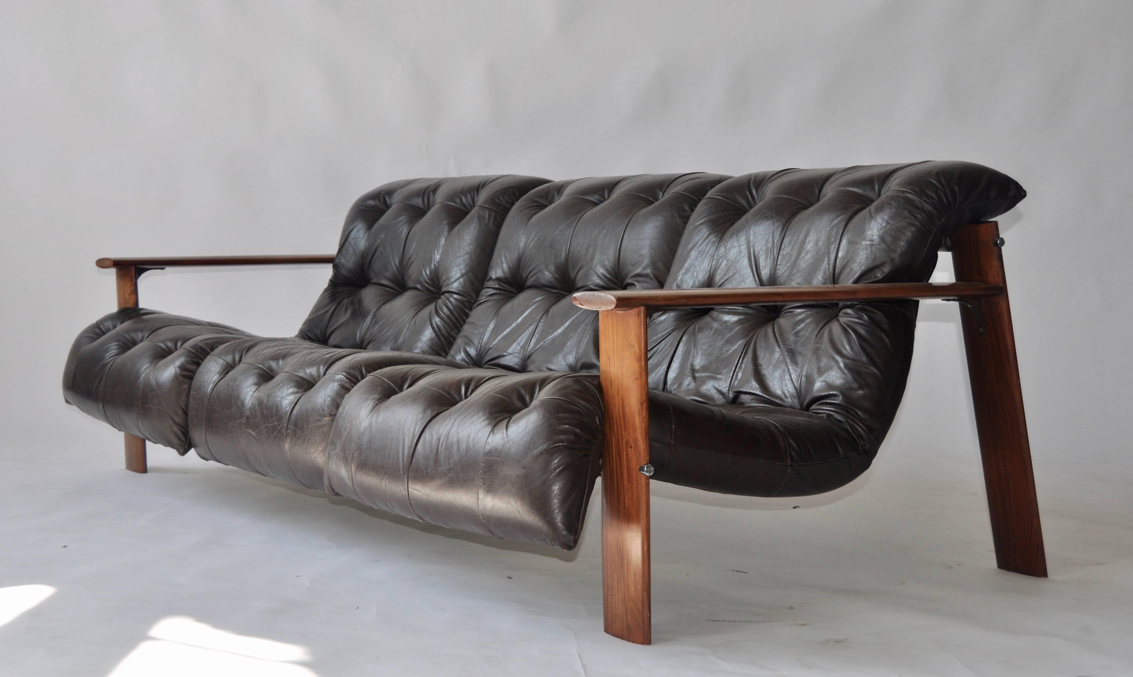 Rosewood and leather sofa by Percival Lafer. Three individual dark brown leather seat cushions. Leather and canvas strapping. Produced by Lafer Furniture.
