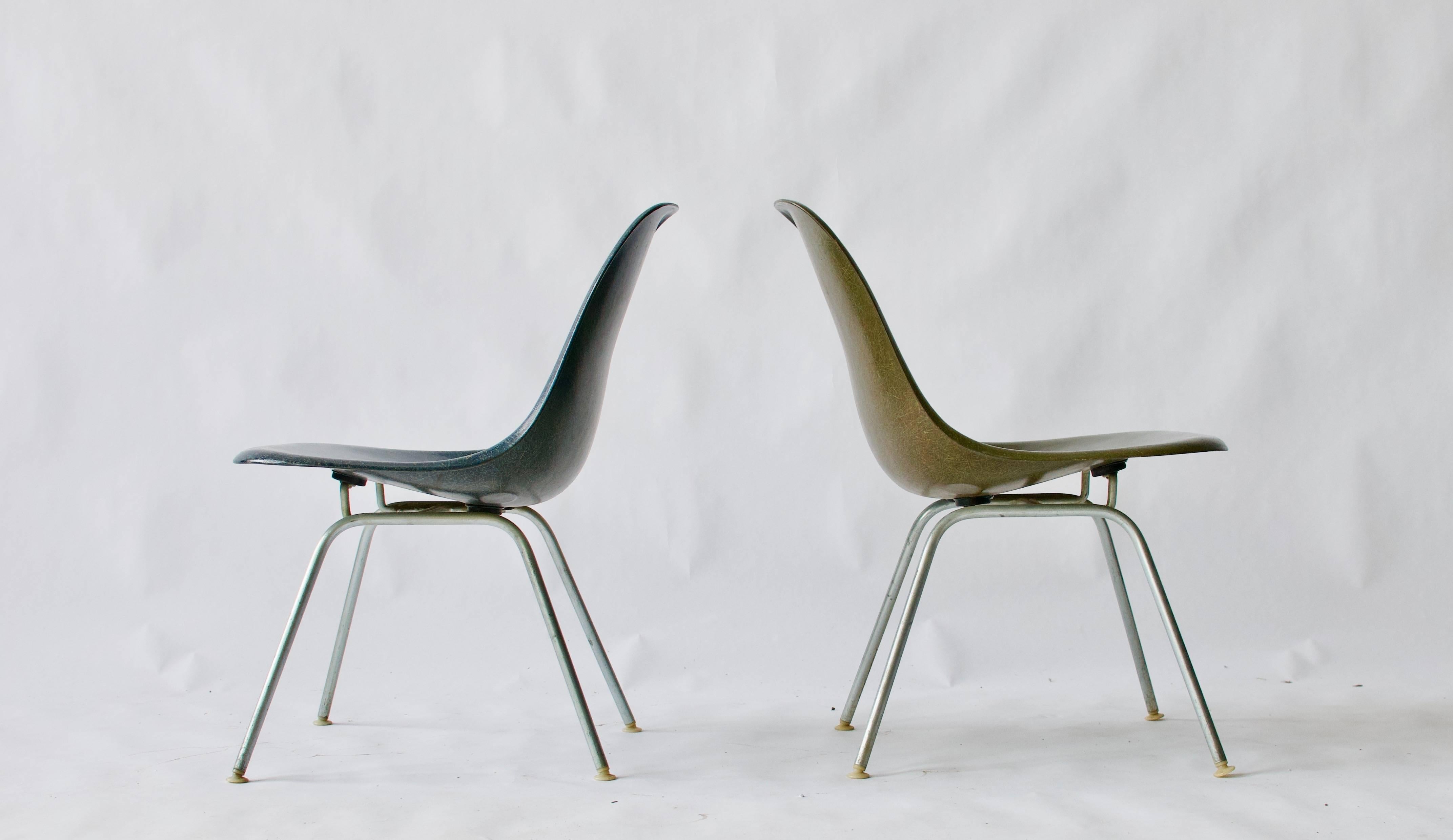 Pair of Charles Eames shell chairs with rare low lounge bases. Colors are green and blue. Herman Miller.

Priced as a pair but would sell individually.