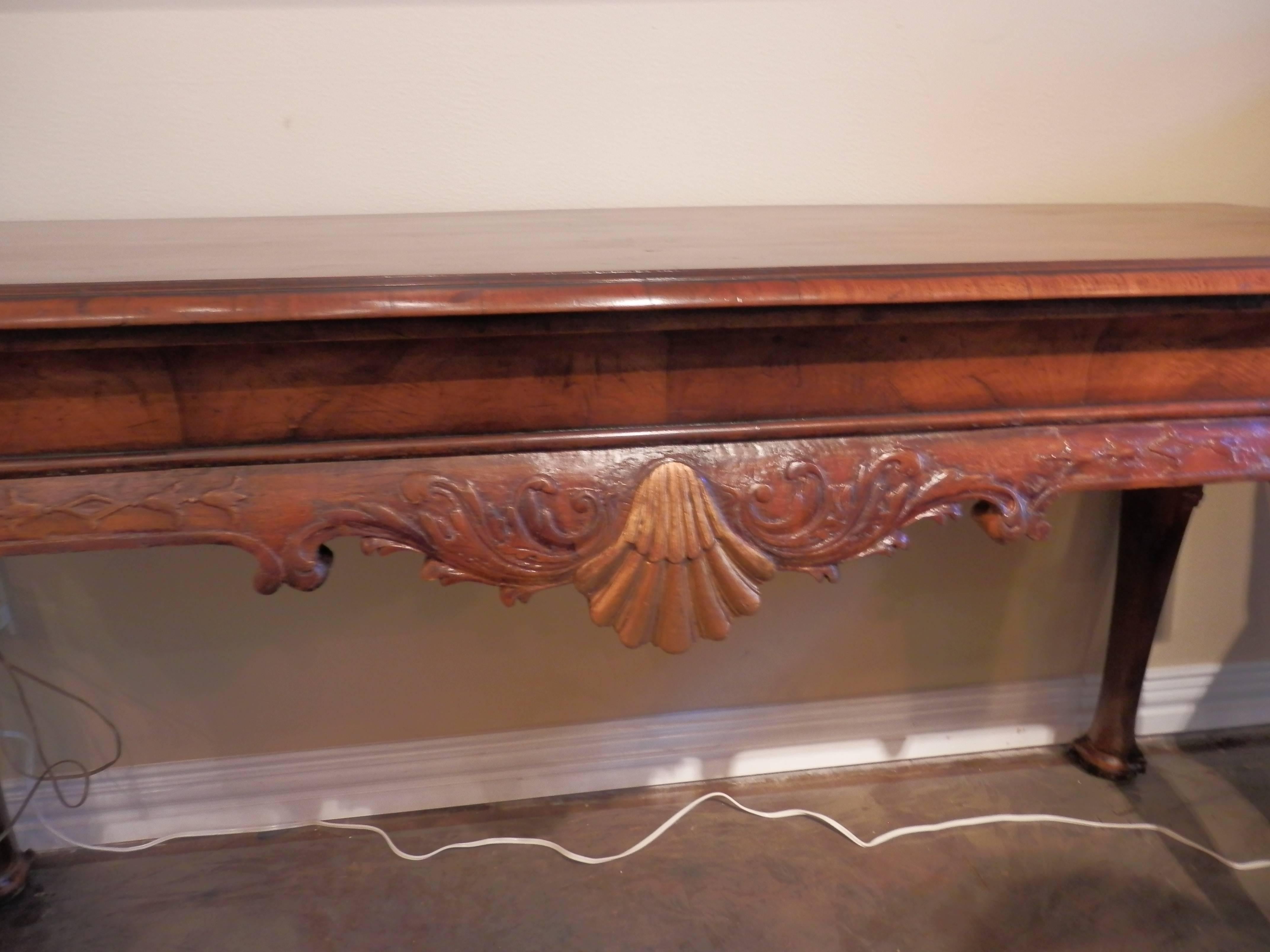 19th century Queen Anne pad foot walnut and parcel-gilt console table. Beautiful carved shell design in the middle. Beautiful burled walnut matched grain top.