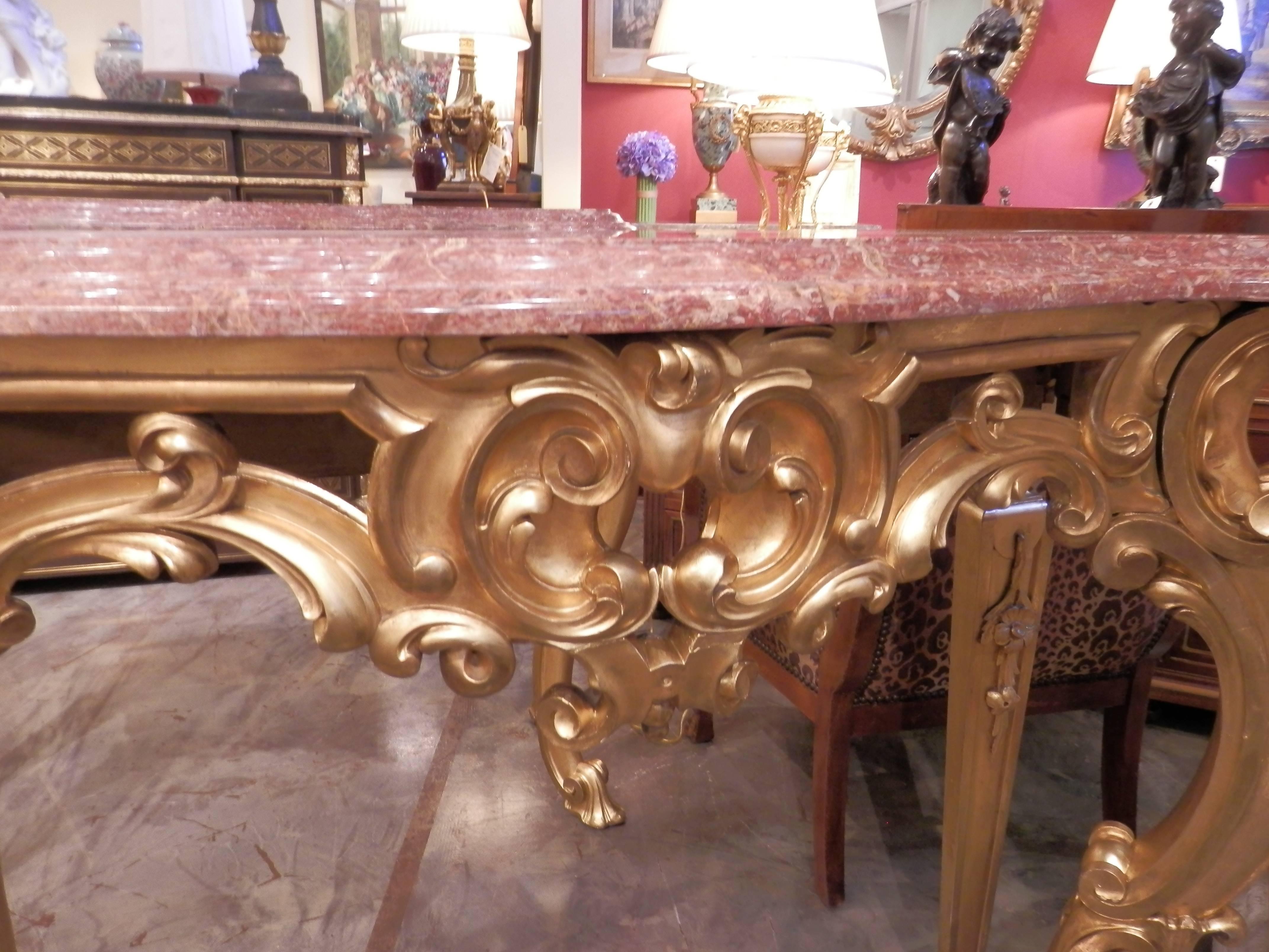 Pair of 19th century French Louis XV water gilt Rococo hand-carved consoles. Beautiful Empire red marble tops. Fine carved original water gilding.
 
