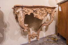 A fine and rare pair of 18th century Regence beechwood marble top consoles.