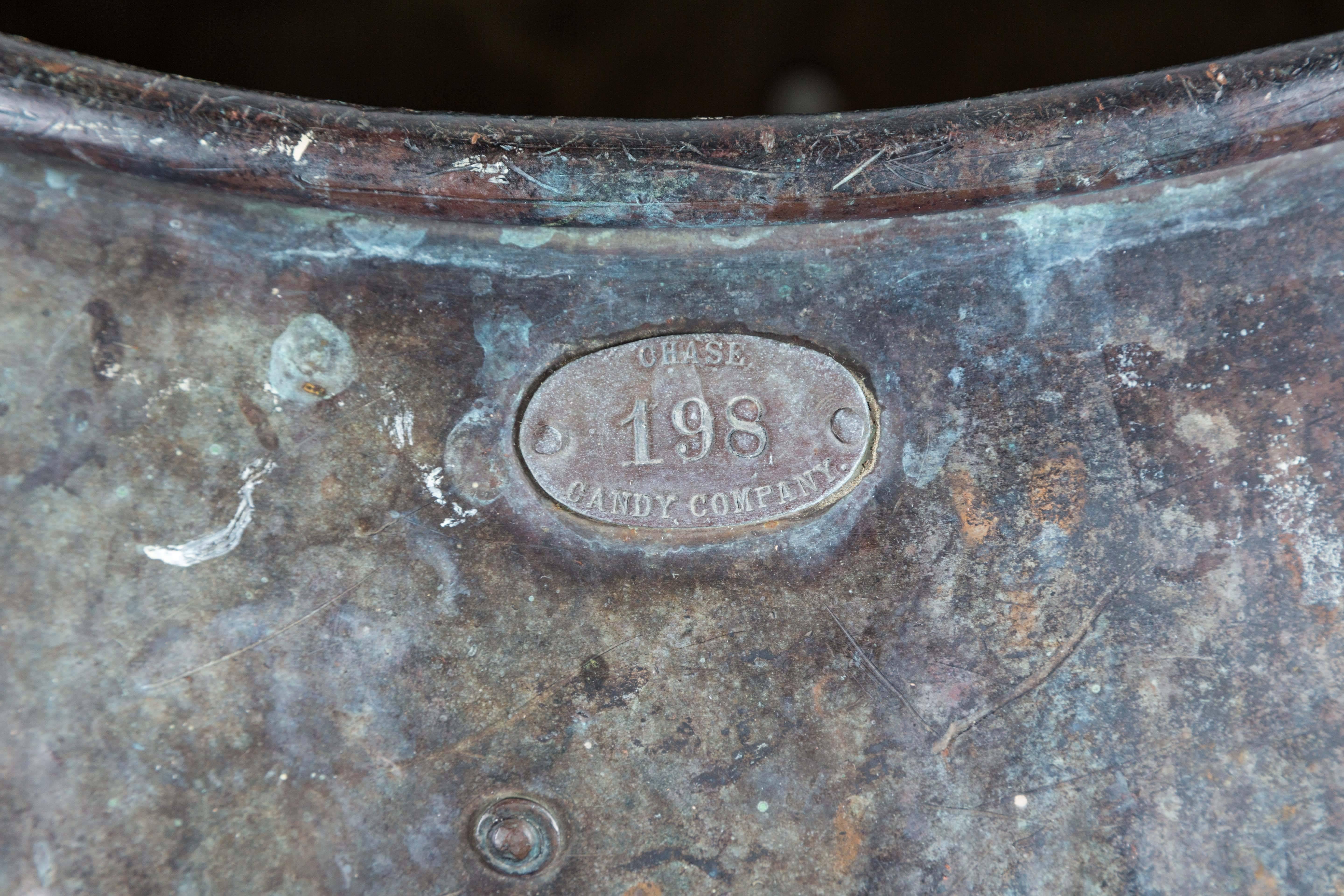 This is one of those things with a great wow factor and story all in one. Substantial hand-hammered copper kettle from the Chase Candy Company in St. Louis, Missouri. Impressive scale and rolled rim with original brass factory tag marked 