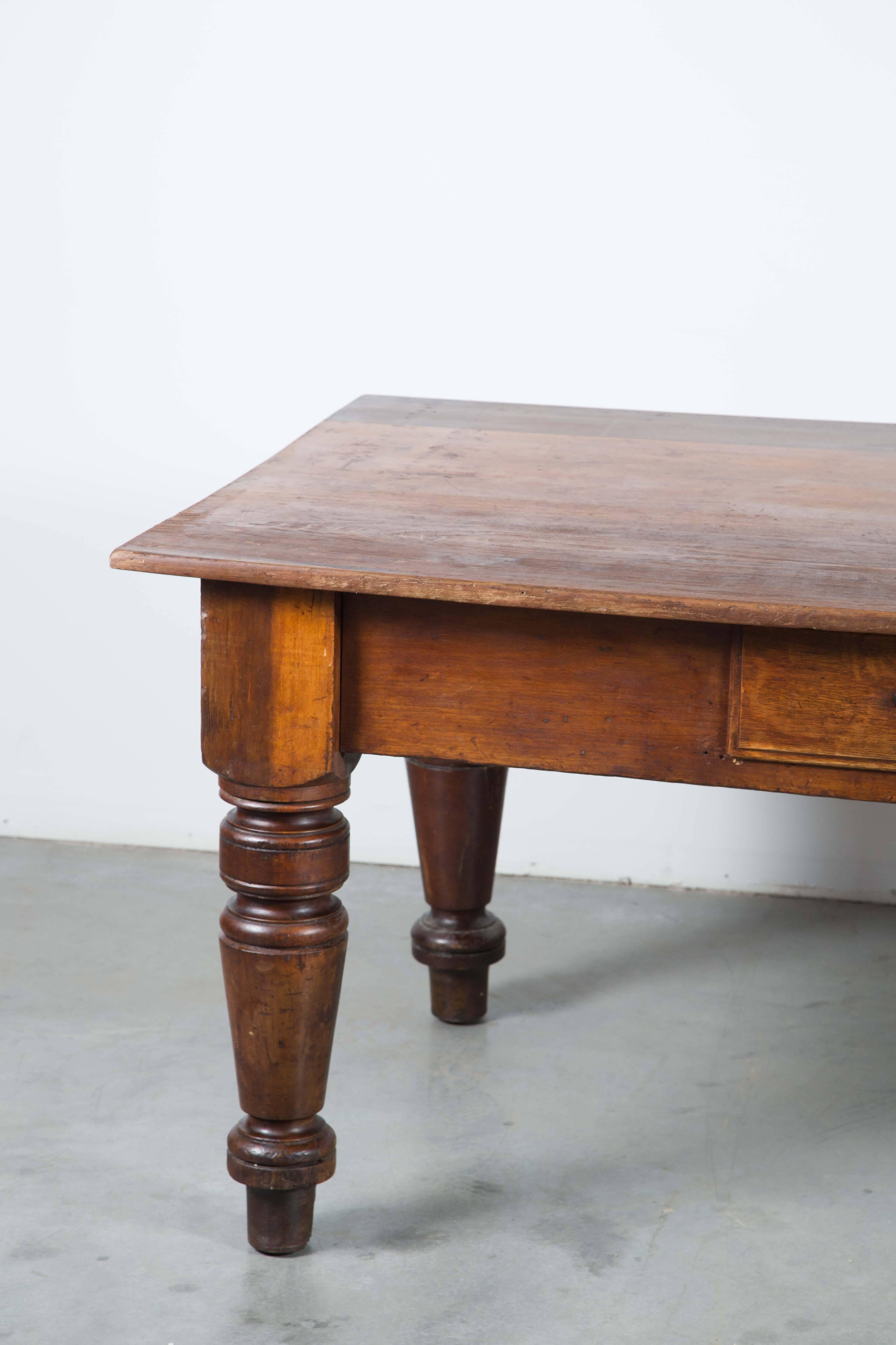 Late 19th century harvest table or store counter with fantastic chunky turned legs. Very solid and sturdy table with three large drawers.