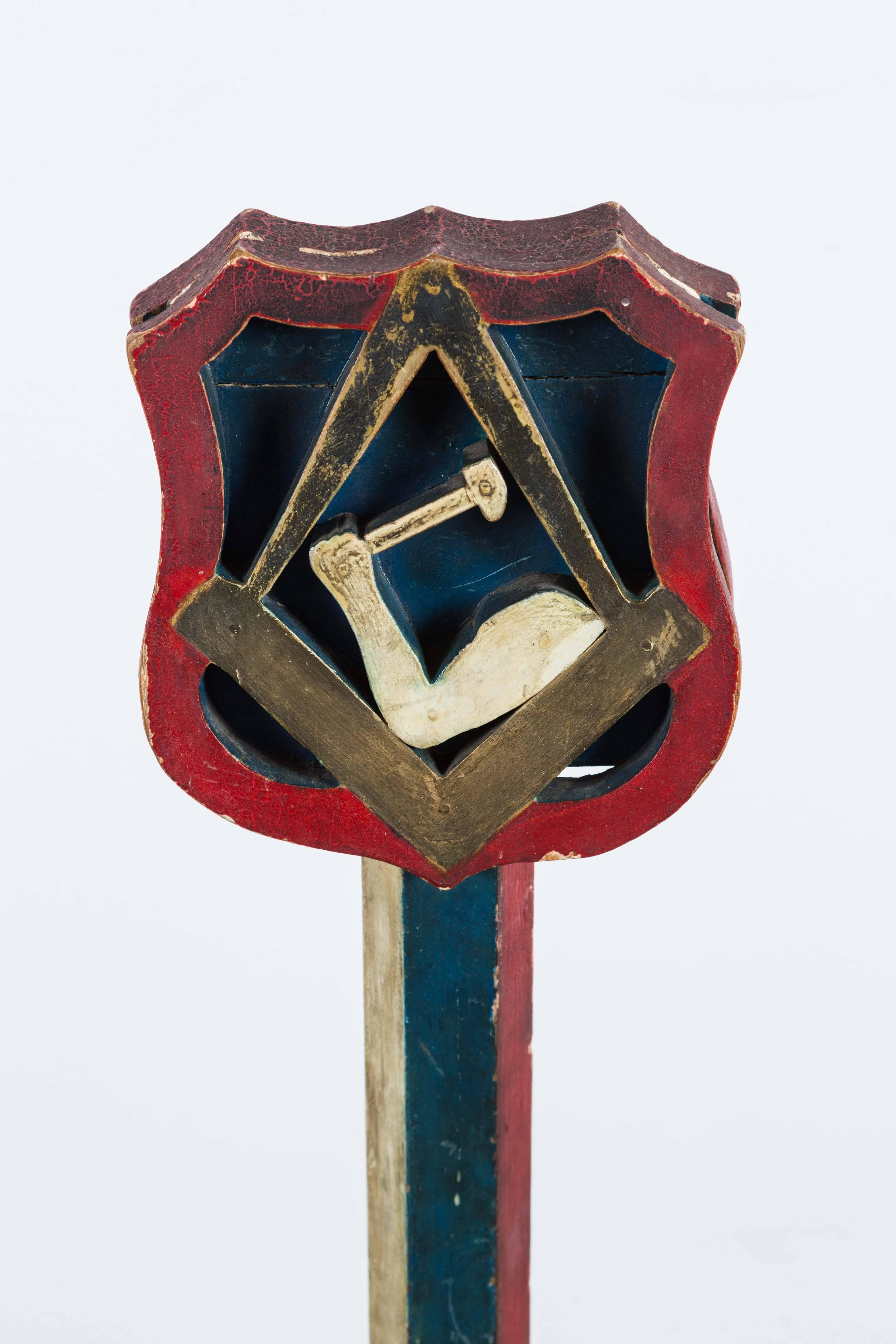 Early 20th century, American Masonic sign with compass and square symbols and arm and Hammer symbol. Great original red white and blue paint surface. Most likely was used as part of a ritual for the masons or other Masonic fraternal organization.
