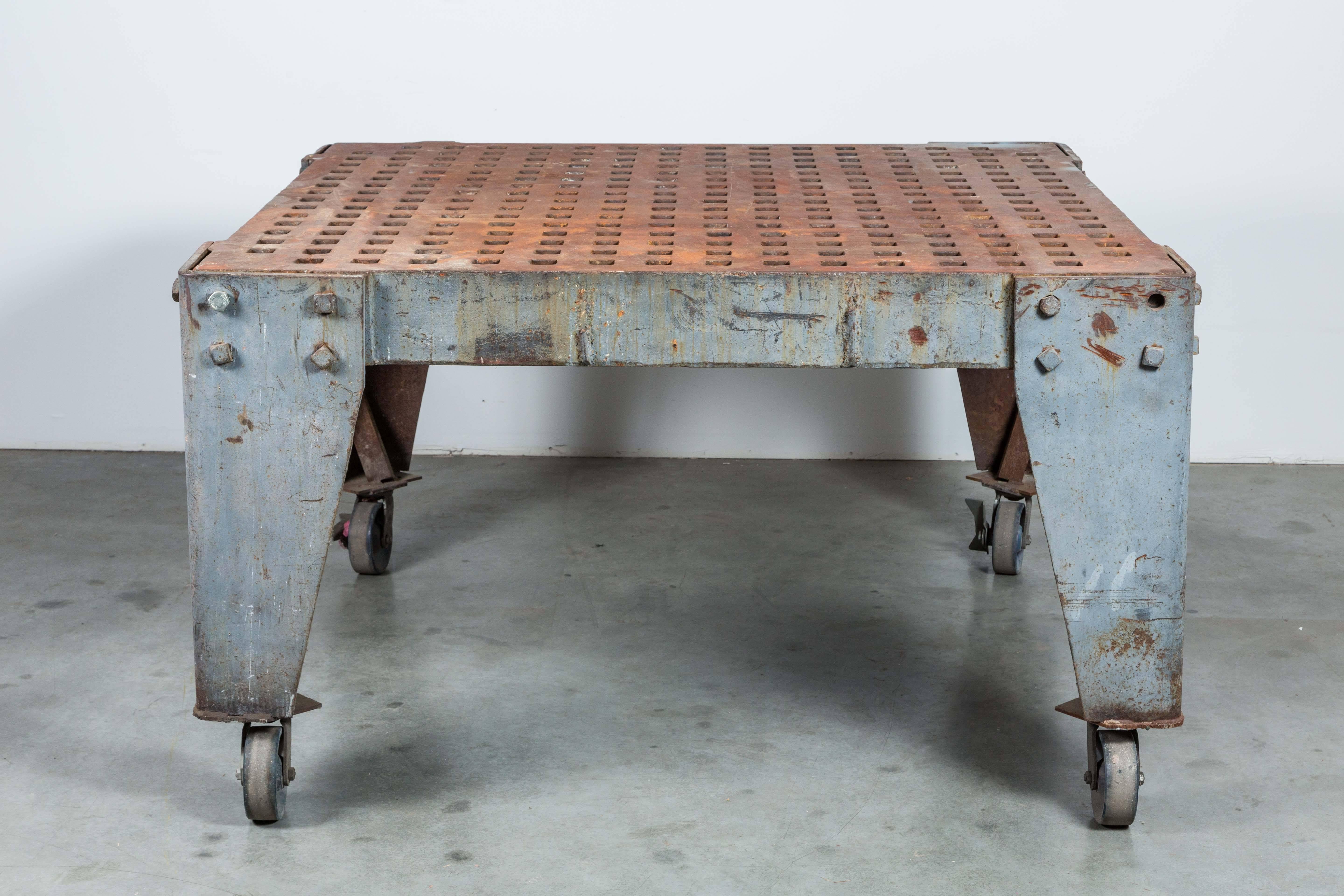 Amazing retail display or loft dining table made of solid cast iron. Originally a welder's table and work surface. On casters which could be removed to lower table height. Would make a great kitchen island as well. Please note that this table weighs