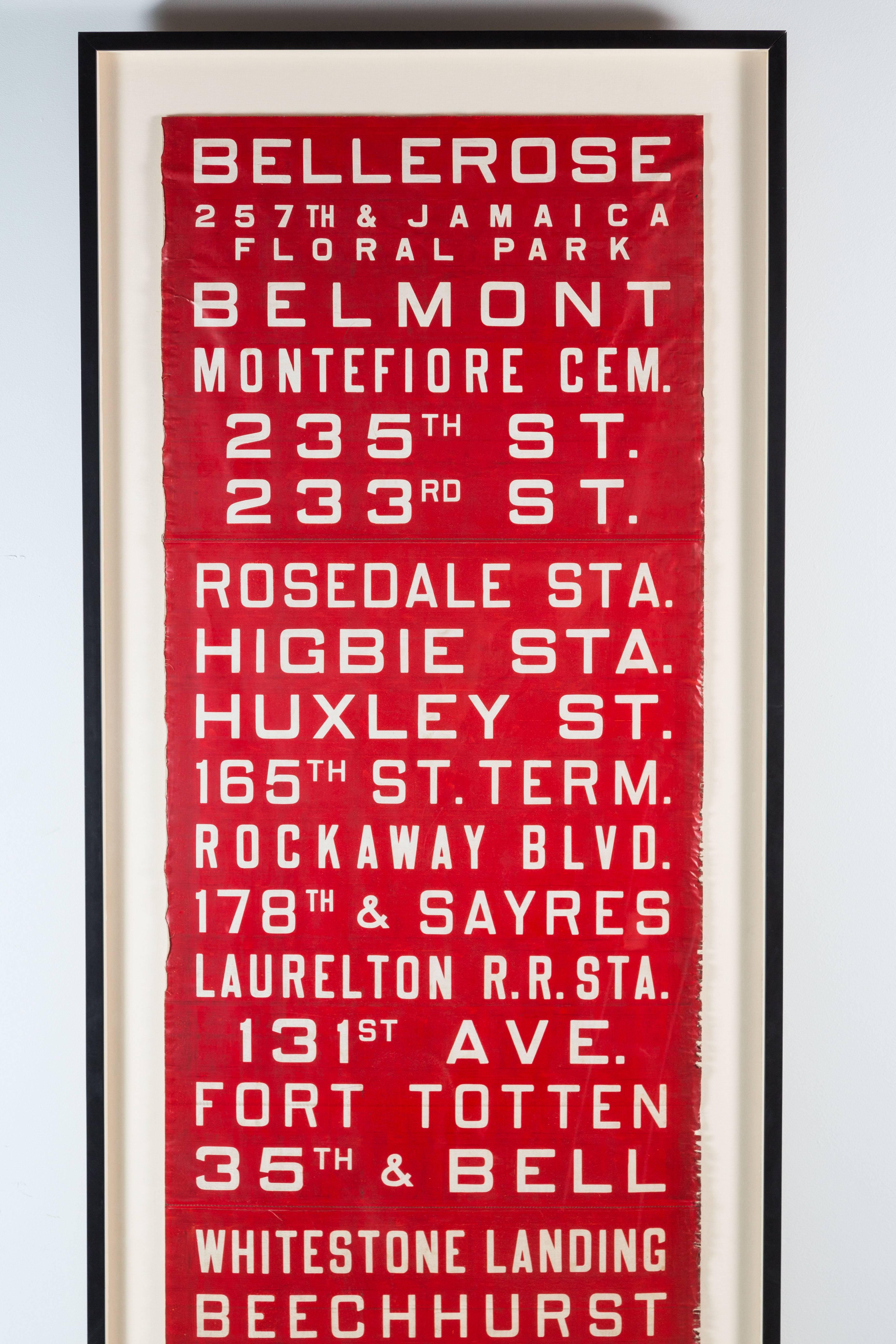 Very large New York bus destination sign. Unusual in red. Very graphic. Bottom of roll was date stamped 1951. 7 1/2 feet tall.