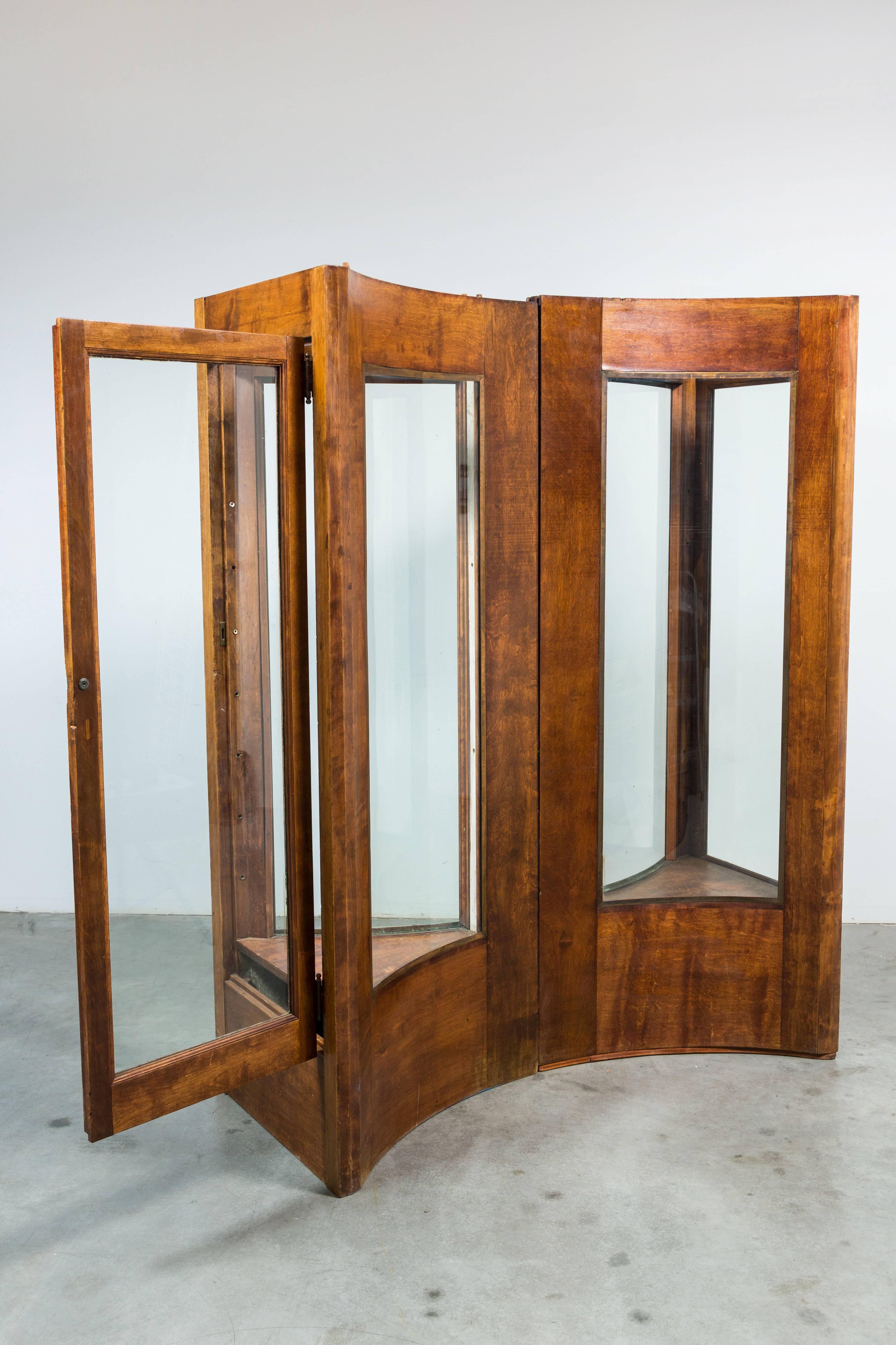 Fantastic oak display cases. Join together to form a bowtie shape. Each has one door for access and original glass shelves (not shown in images). Very solid and sturdy. Great and unusual display option with a fun history. 