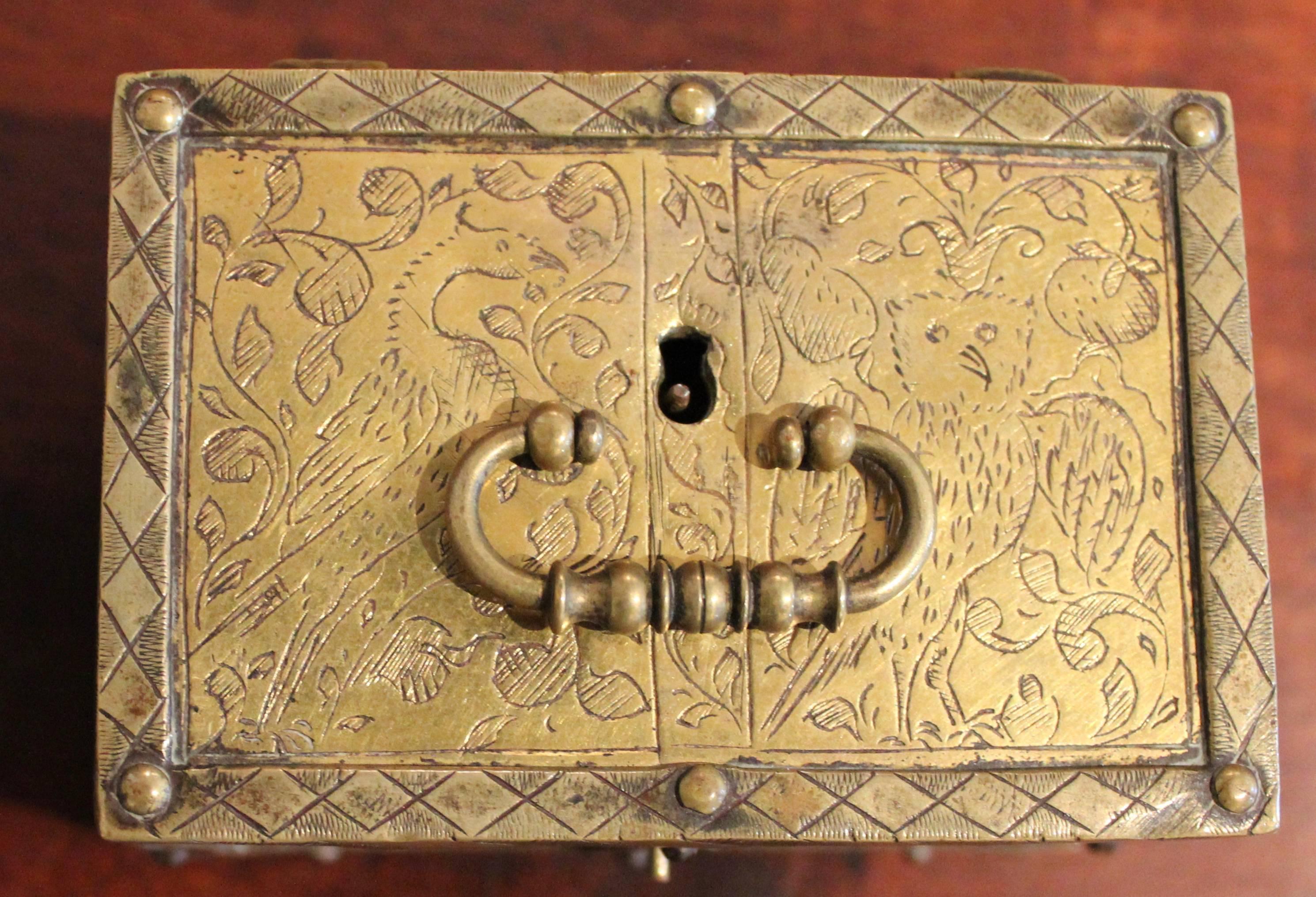 Very rare miniature brass casket. Wonderfully engraved with birds a goat, rabbit and snail with floral designs. His boxes are typically engraved with figures and faces making this one unique.