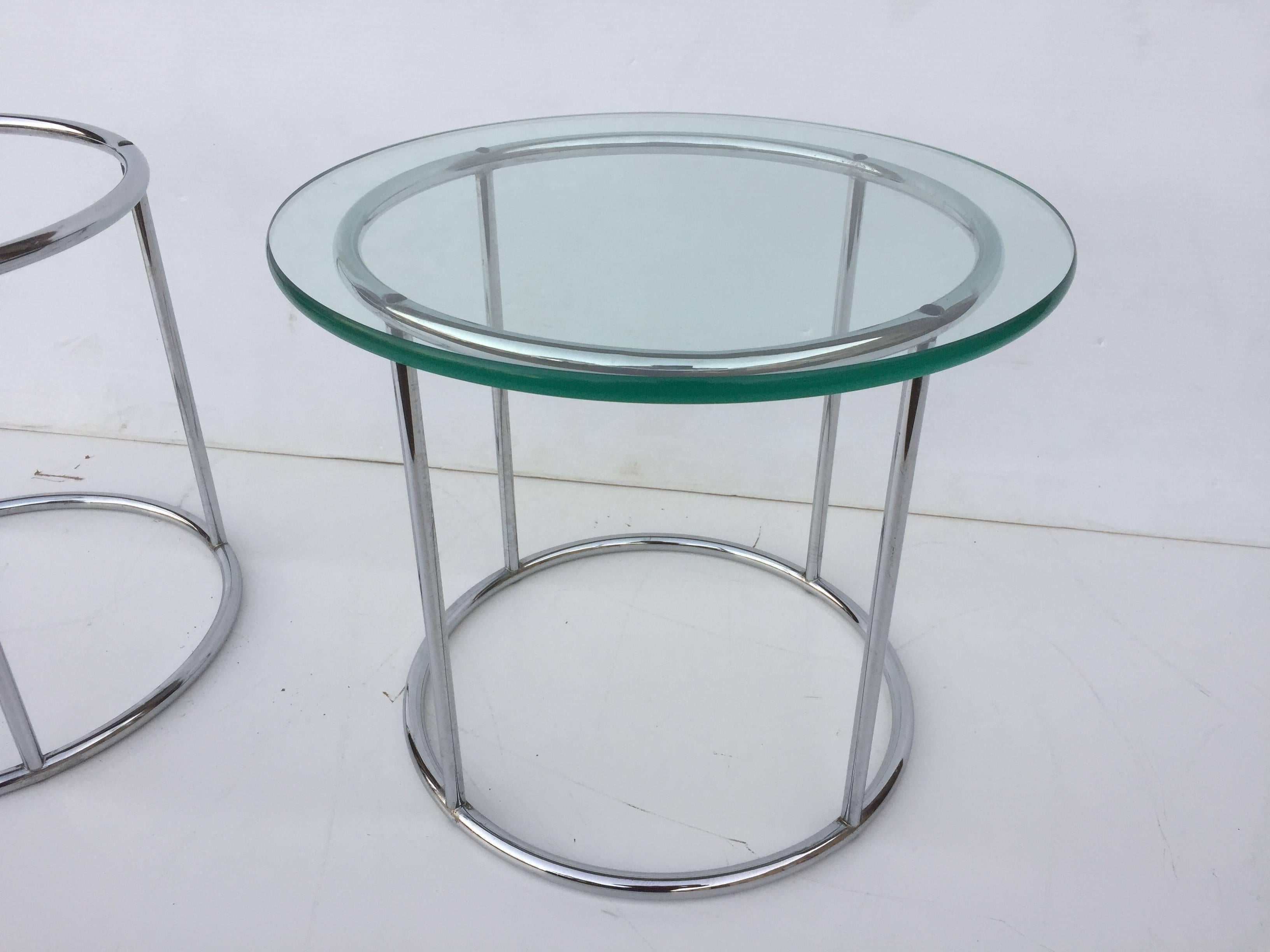 Pair of petite four post circular chrome frame side tables in the manner of Milo Baughman.