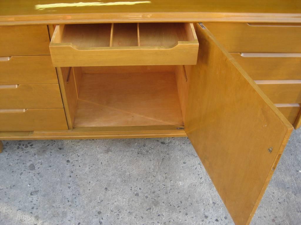 Gorgeous fully restored Edmond J. Spence Floating atop legs Dresser with nine-drawers, and storage comartment server buffet or sideboard by Edmund J. Spence, which later was discovered to be a Typo of Edmond, iridescent grain flamed maple. With