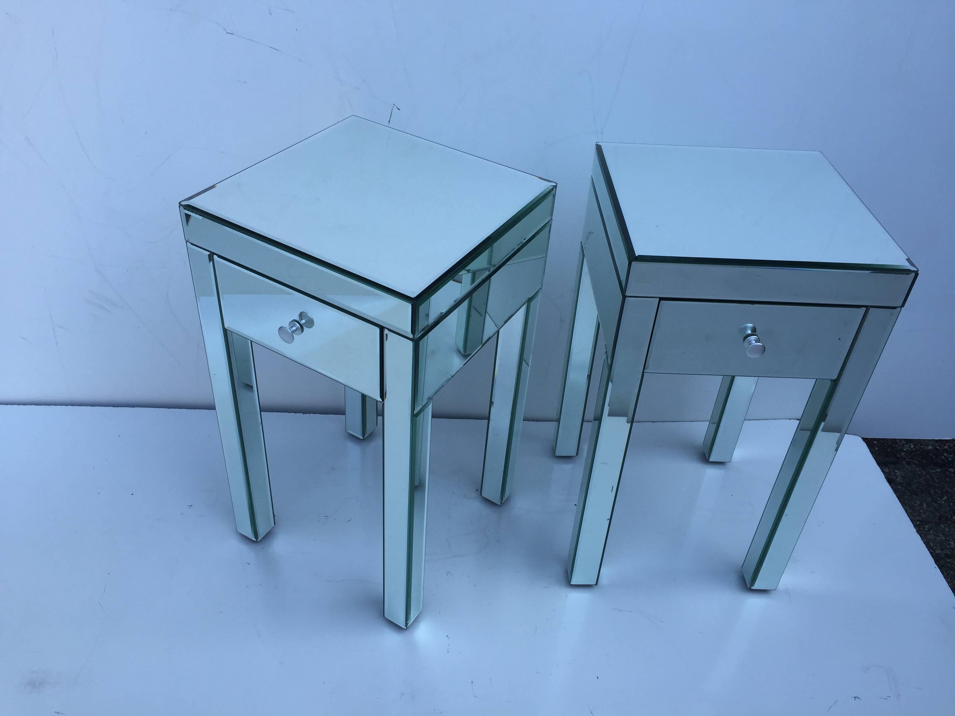 Pair of small tall floating fully mirror clad nightstand petite side tables.