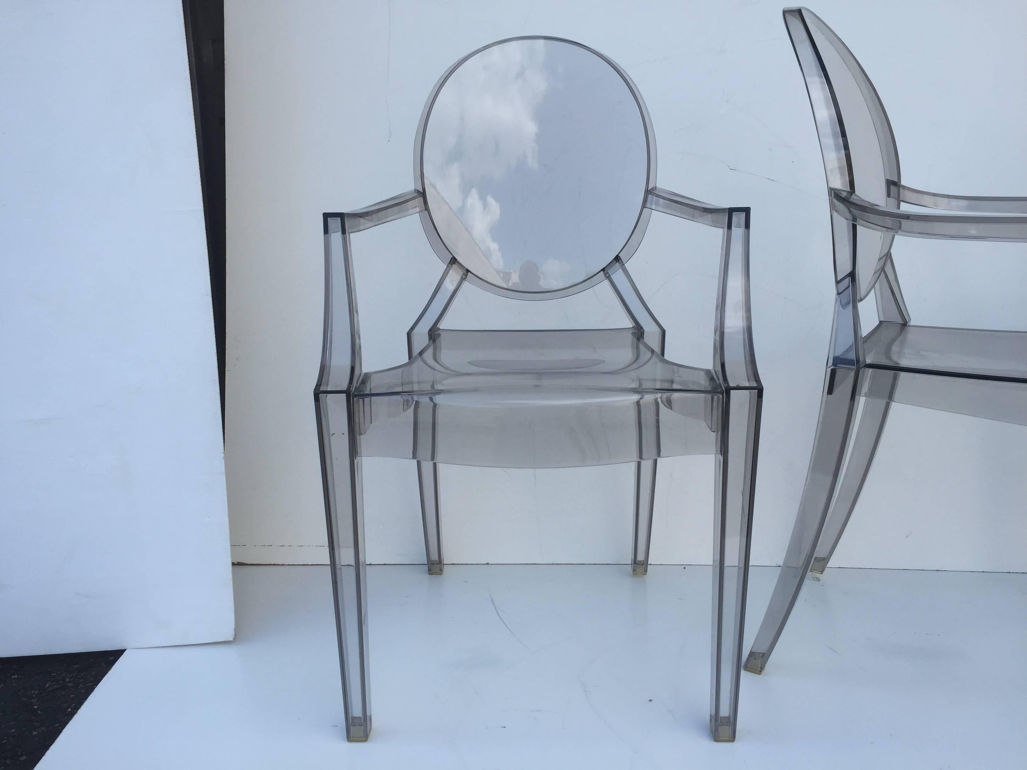 Smoked Lucite individual Philippe Starck or as set of three-arm Louis Ghost and pair of side Victoria Ghost chairs by Kartell available individually. Armchairs measures: D 21.5 H 36.75 W 19 S 19 A 27 all 3 39.25 side chairs: D 19.25 W 15.25 H 35.75