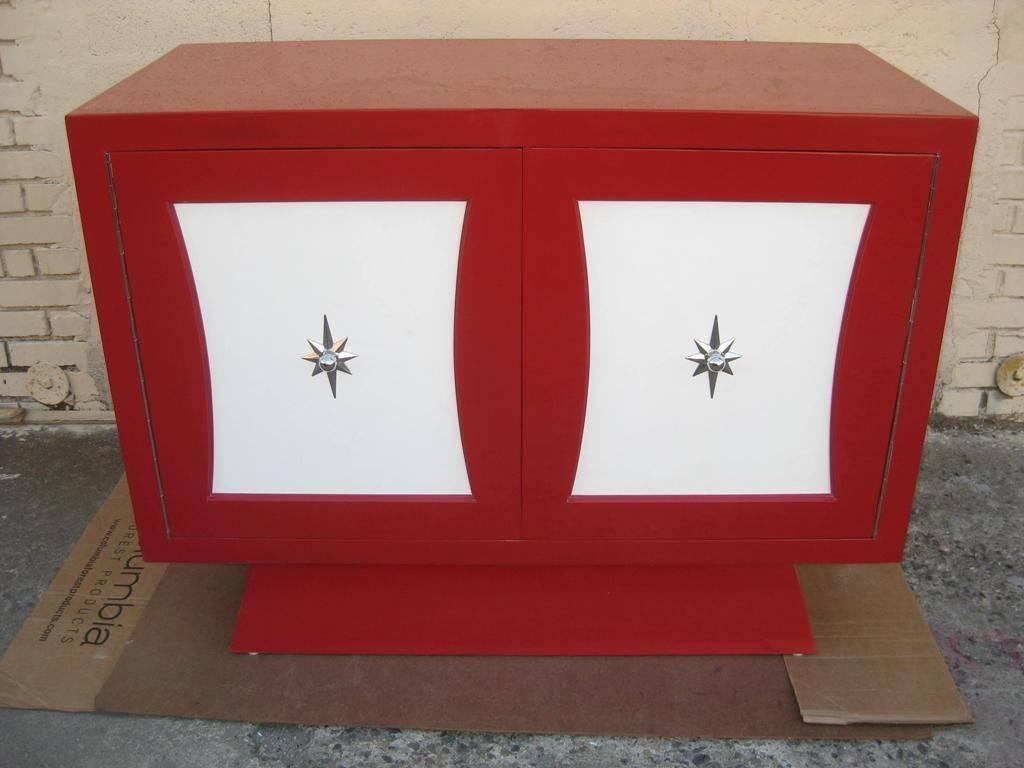 Petite red dresser with door for 3 drawers and tapered base in the manner of Grosfeld House and Tommi Parzinger Style Hardware, can double as sideboard server commode, very captivating center and conversation piece to build on. 