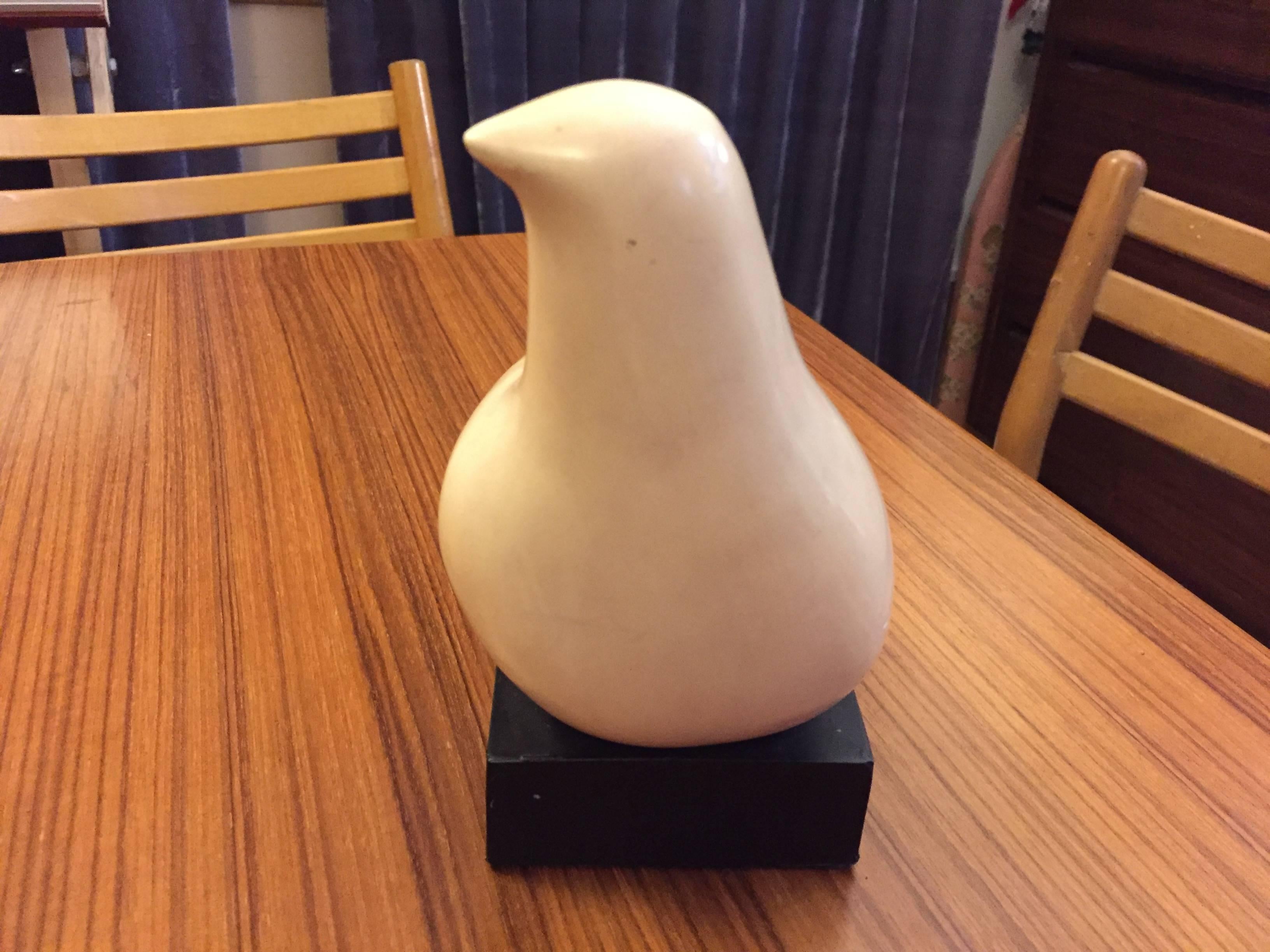 Small white dove mounted on small pedestal.