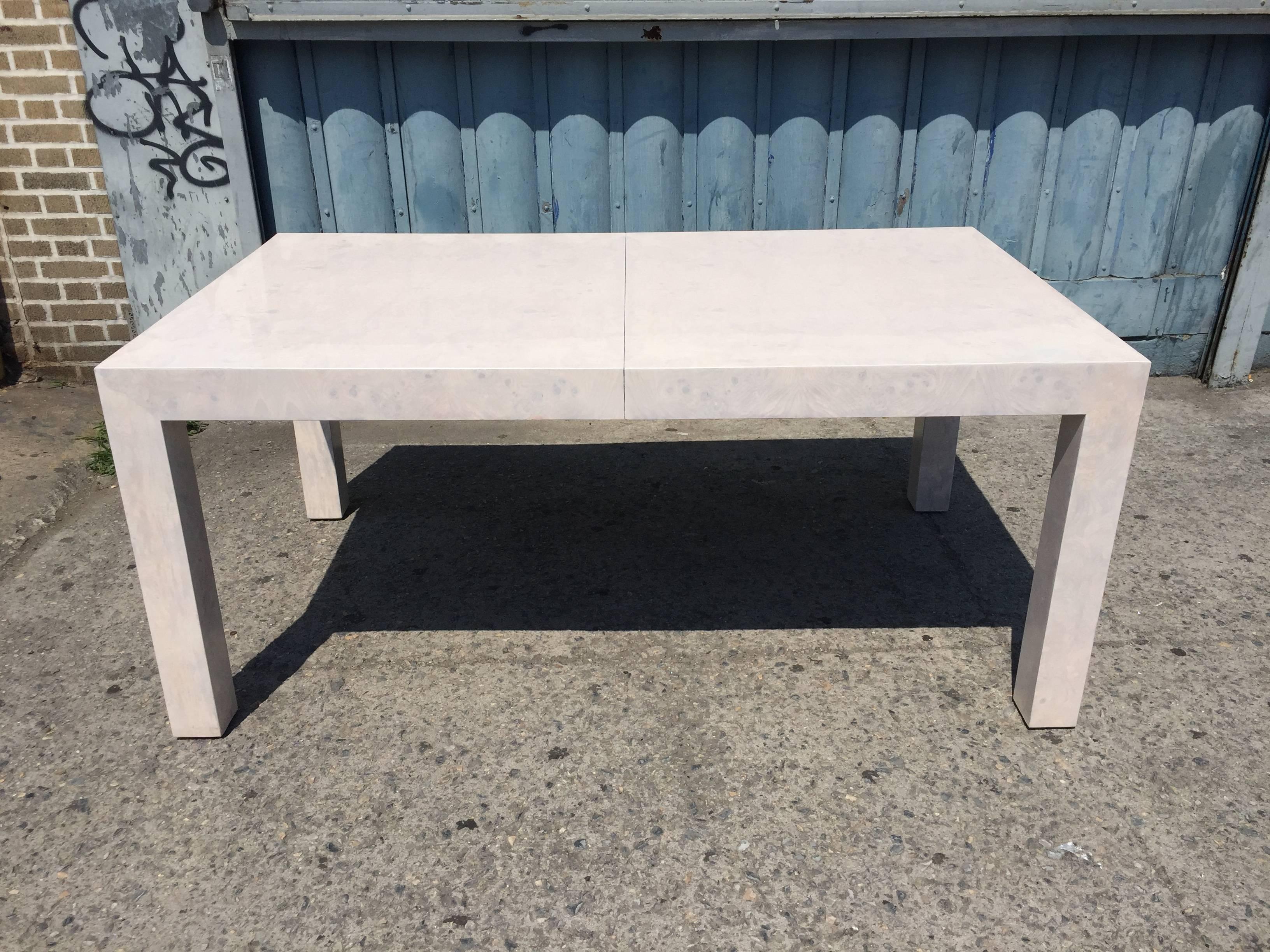 Whiteweashed burled parsons design dining table by Milo Baughman, this table Is designed to but does not have any leaves, thus this item has been posted as clearance.  The finish is professional and this table is absolutely stunning.
