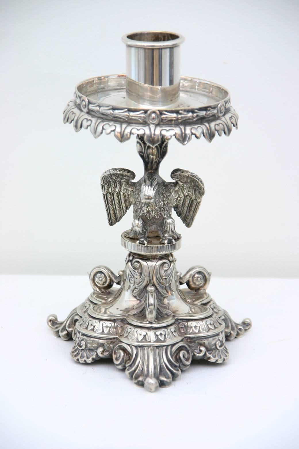 A 19th century English, Sheffield silver plated candle stand decorated with an eagle above a shell and acanthus leaf base.