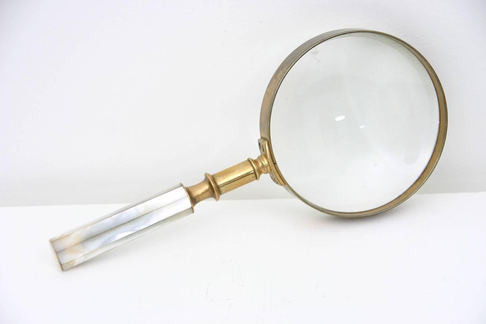 A 19th century mother-of-pearl and brass magnifying glass with original case.