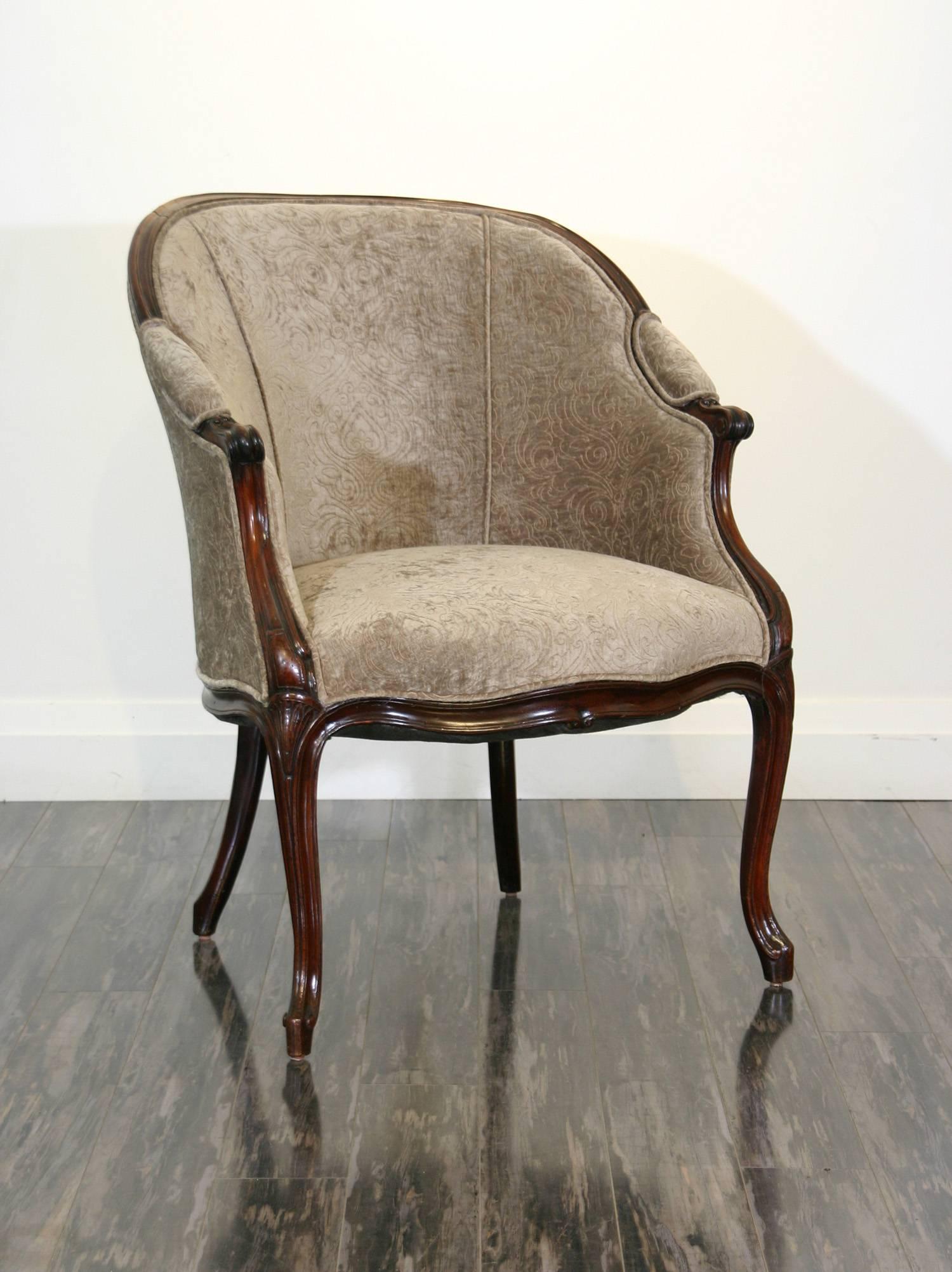 An English George III period mahogany tub chair in the French taste.