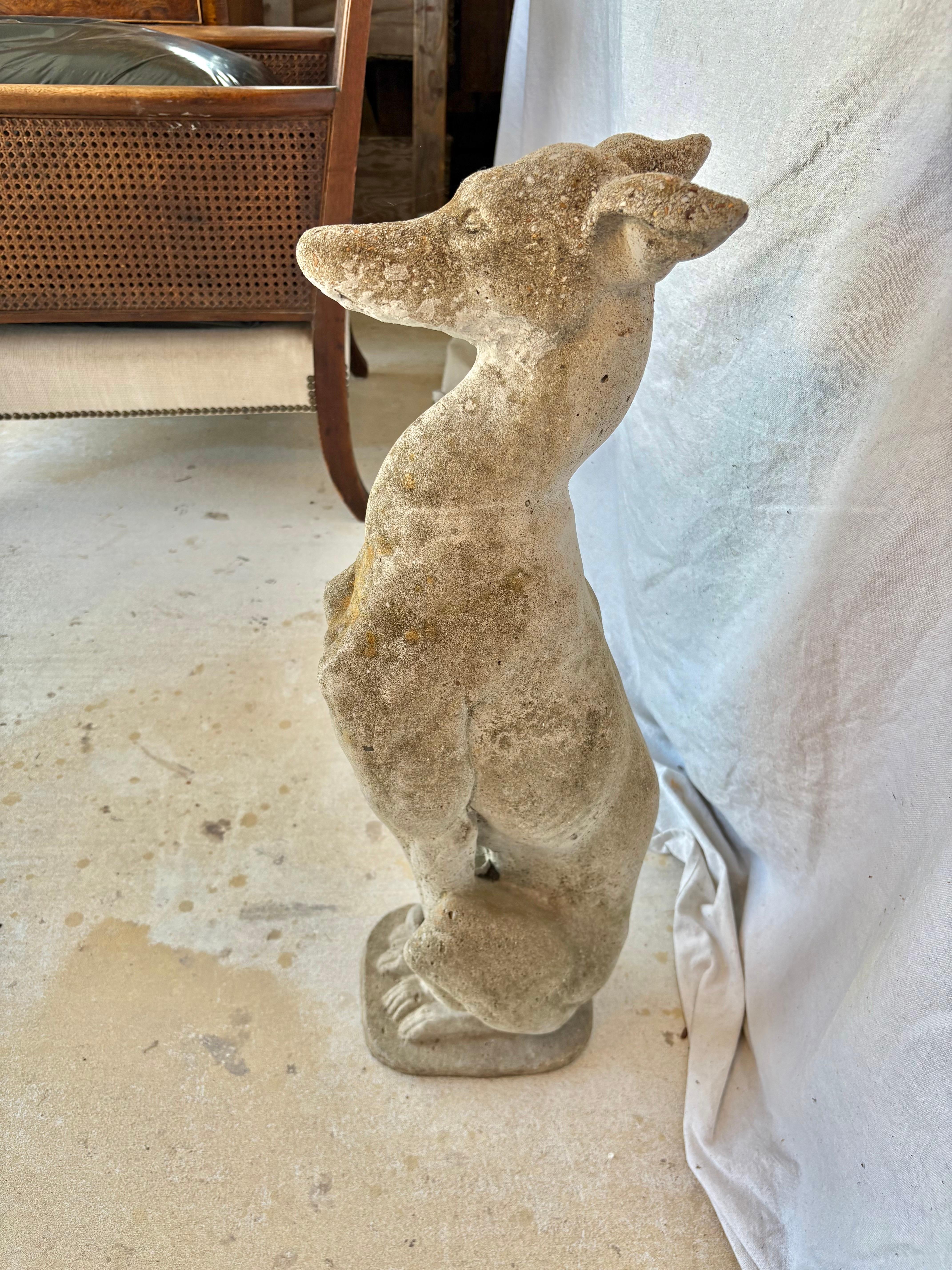 This Early 20th Century Whippet or Greyhound Dog Garden Sculpture was meticulously crafted in France from concrete. The piece with its aged weathered patina, is an exquisite garden ornament showing attention to detail from the dogs head to the feet.