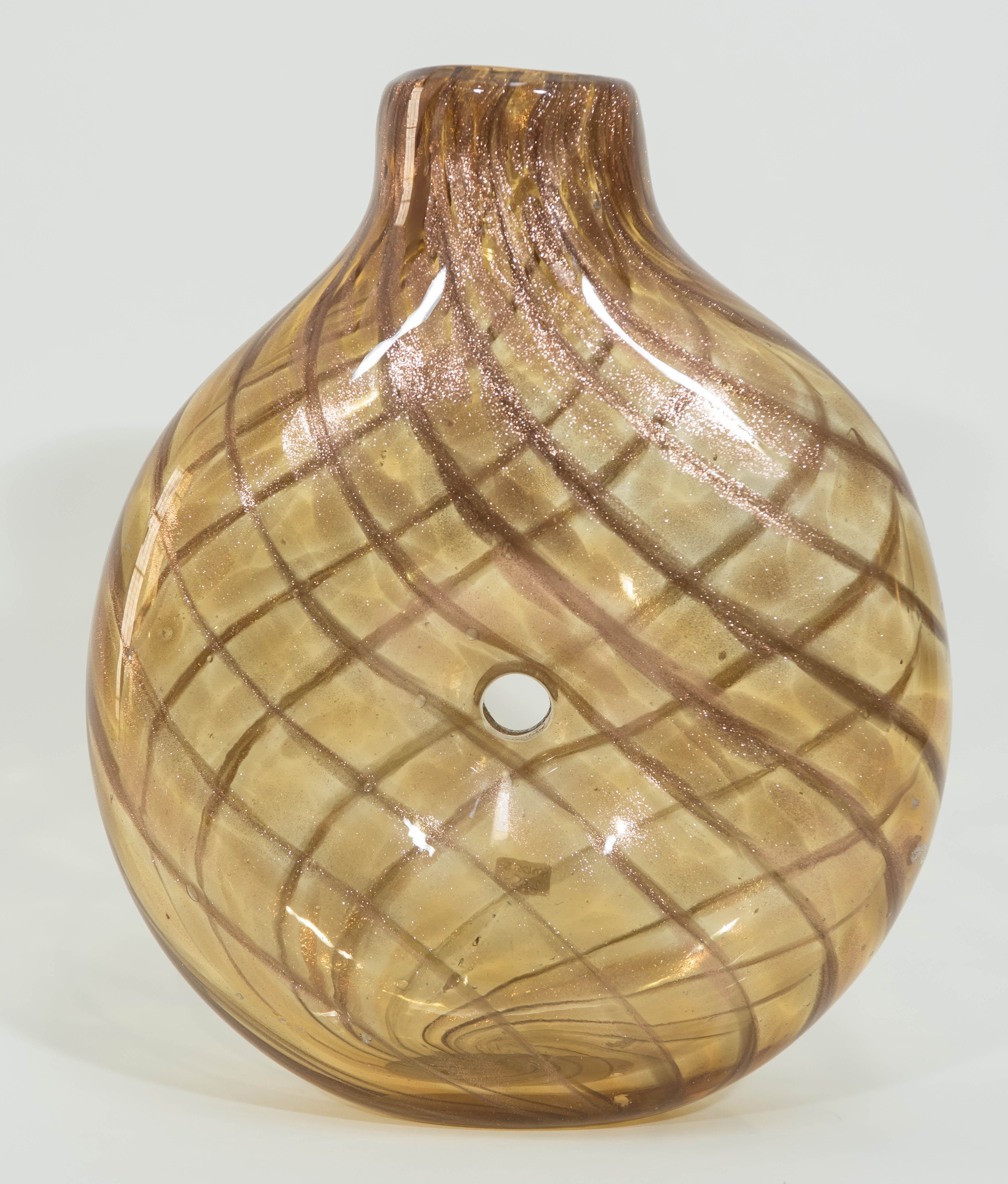 This large and sculptural amber colored Murano vase is infused with an iridescent copper 