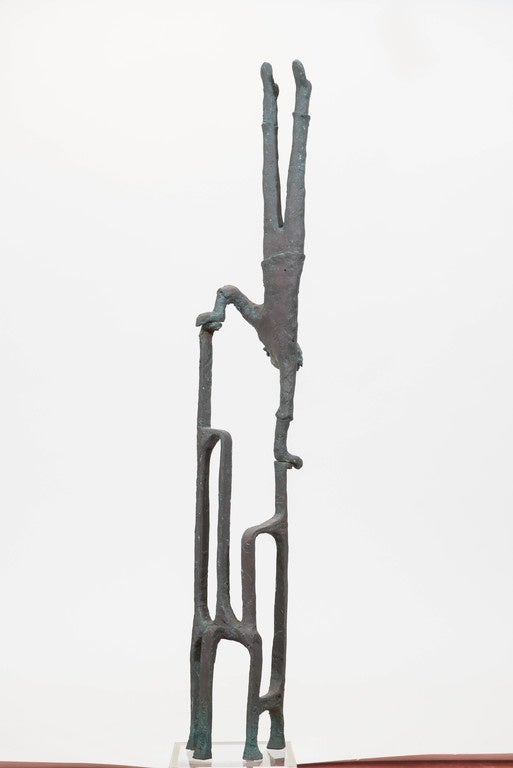 A highly patinated bronze figure of an balancing man or 
