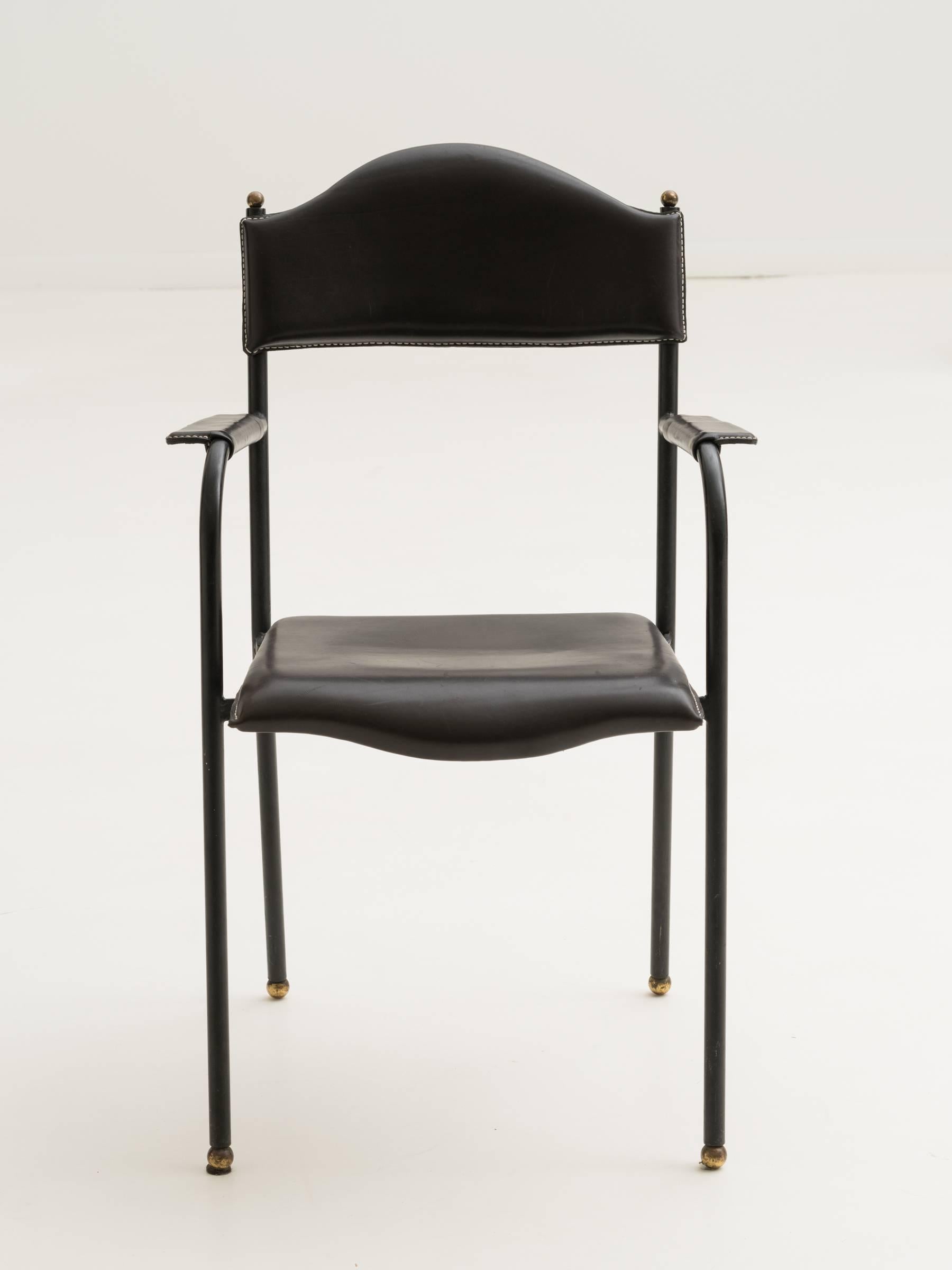 A good stitched black leather and iron armchair by Jacques Adnet.