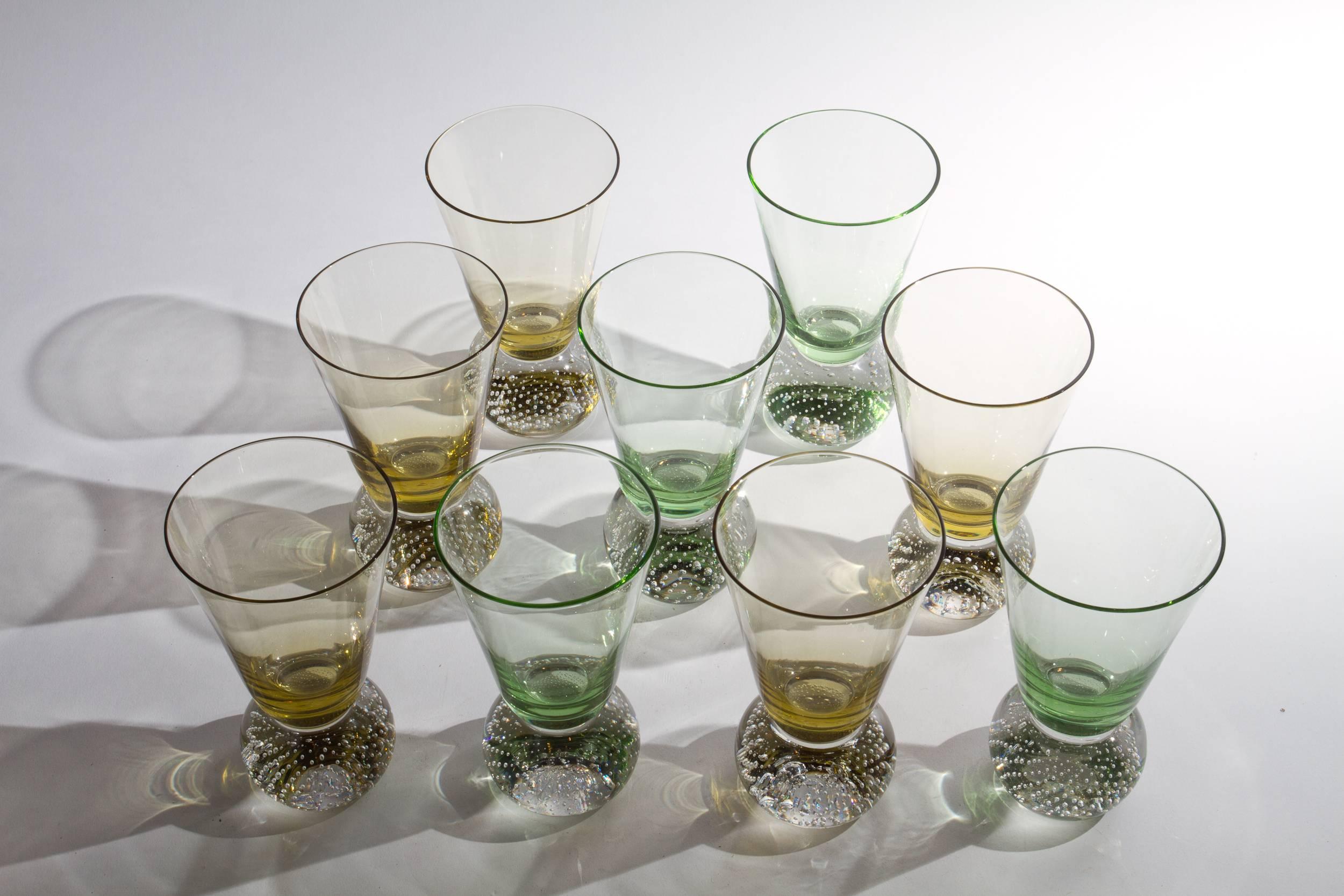 Elegant set of 9 amber and green tumbler bubble glass base by Carl Erickson.