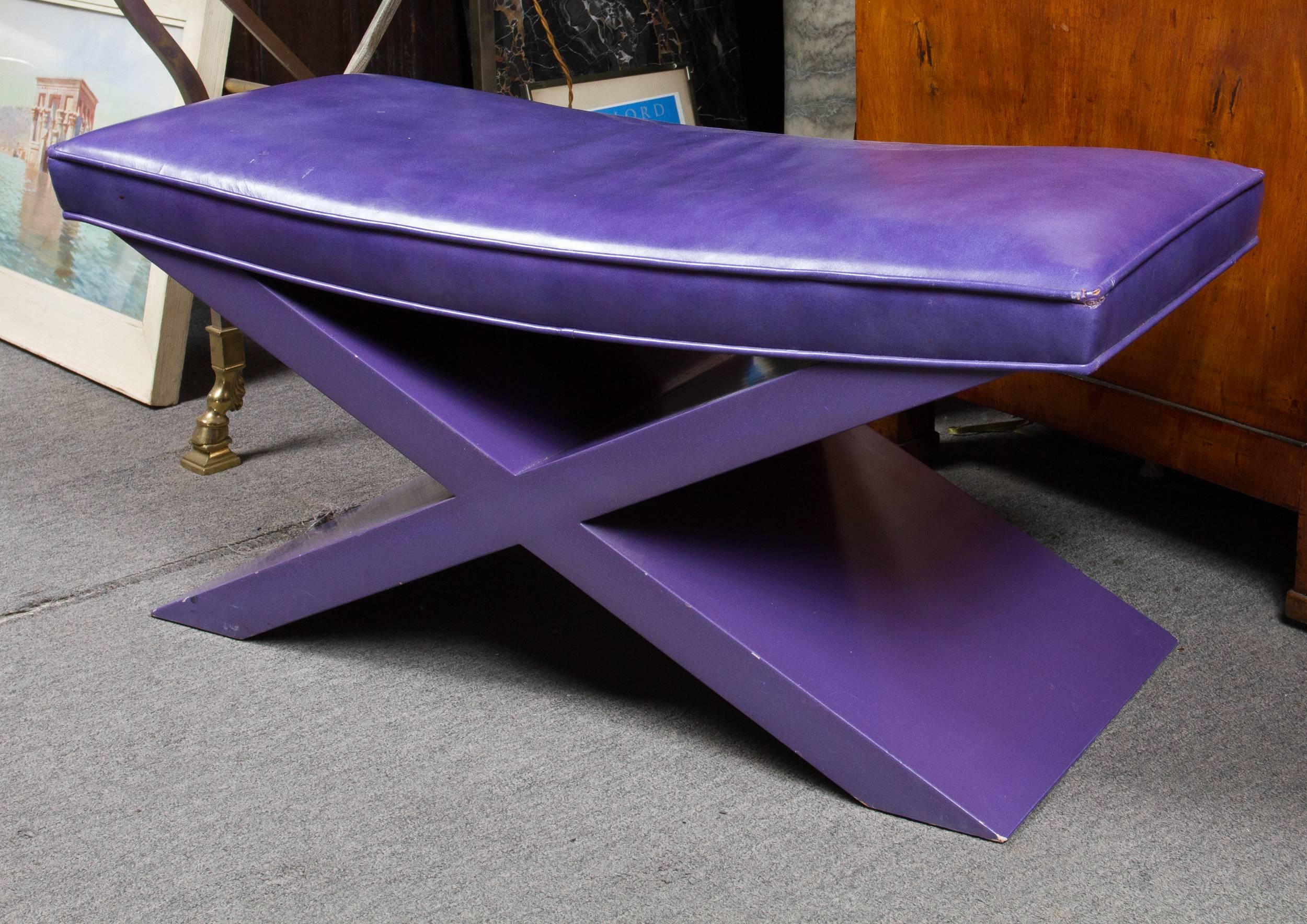 Modernist purple leather bench stool resting on a lacquered wooden base.