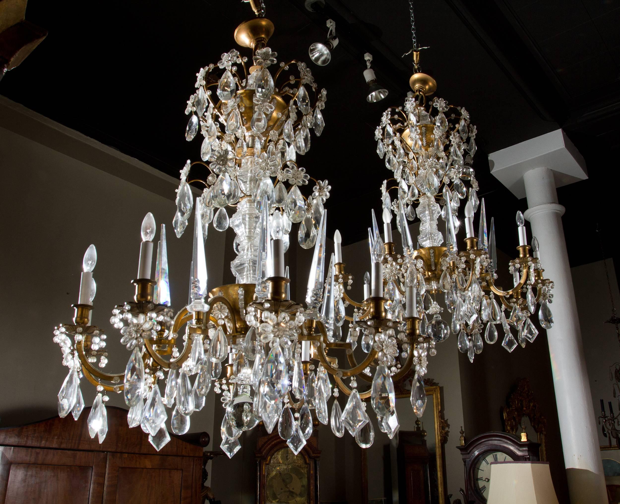 Rare and important pair of 1930s crystal mounted gilt bronze chandeliers by Maison Baguès . Of beautiful proportions these chandeliers are in great original condition, the bronze retaining its original gilding.
  