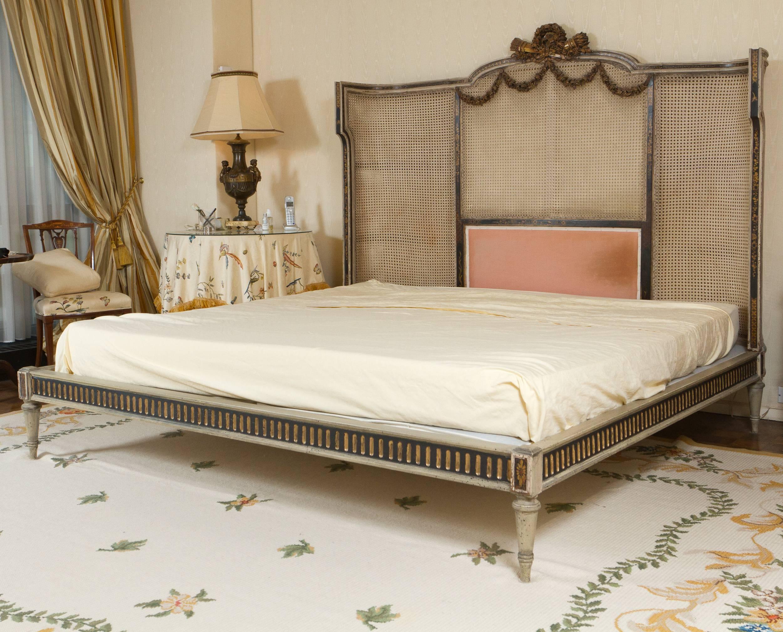 Louis XVI style painted and carved wood king-size bed. The backboard finished with cane-work.

Dimensions: from floor to railing 9.5 inches
                     from floor  to base of mattress 14 inches