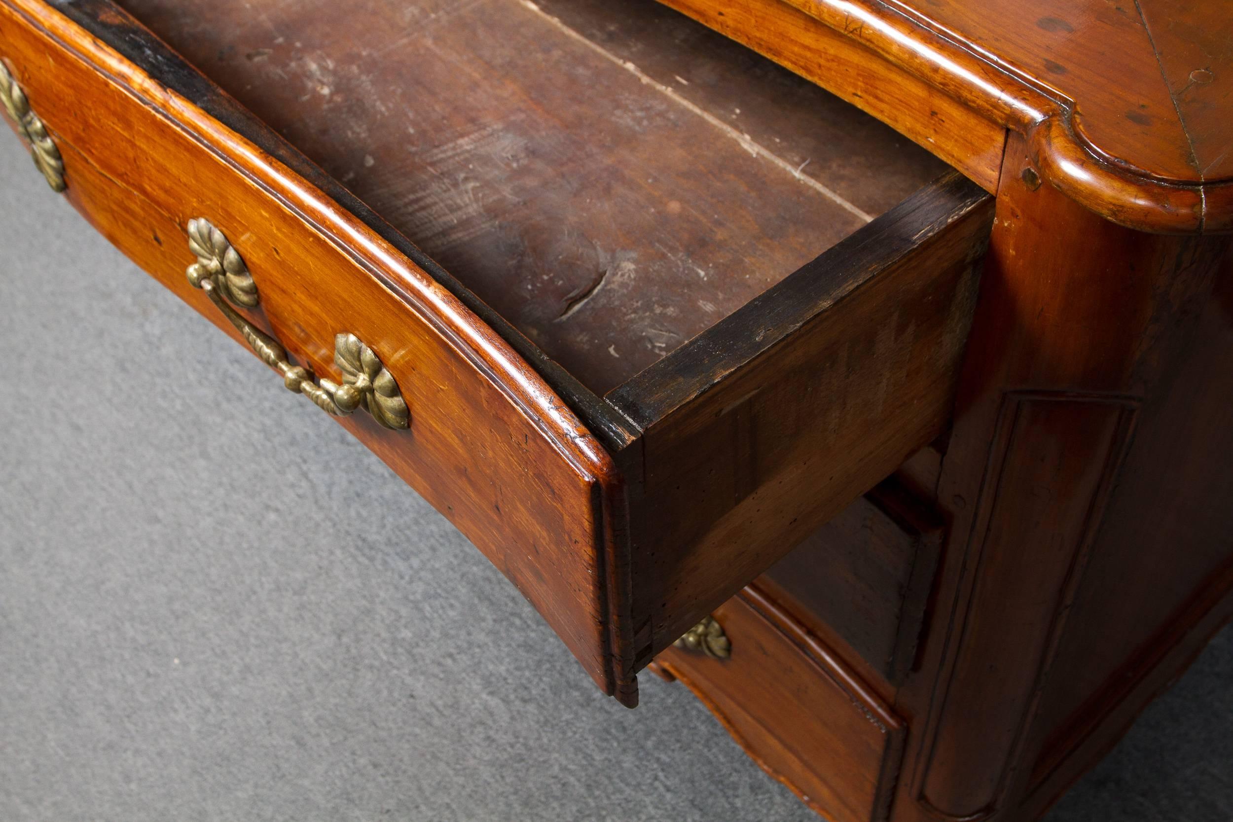 Lovely 18th century French Louis XV period cherrywood arbalete commode with three drawers and decorated with gilded bronze rosette on cabriole legs.