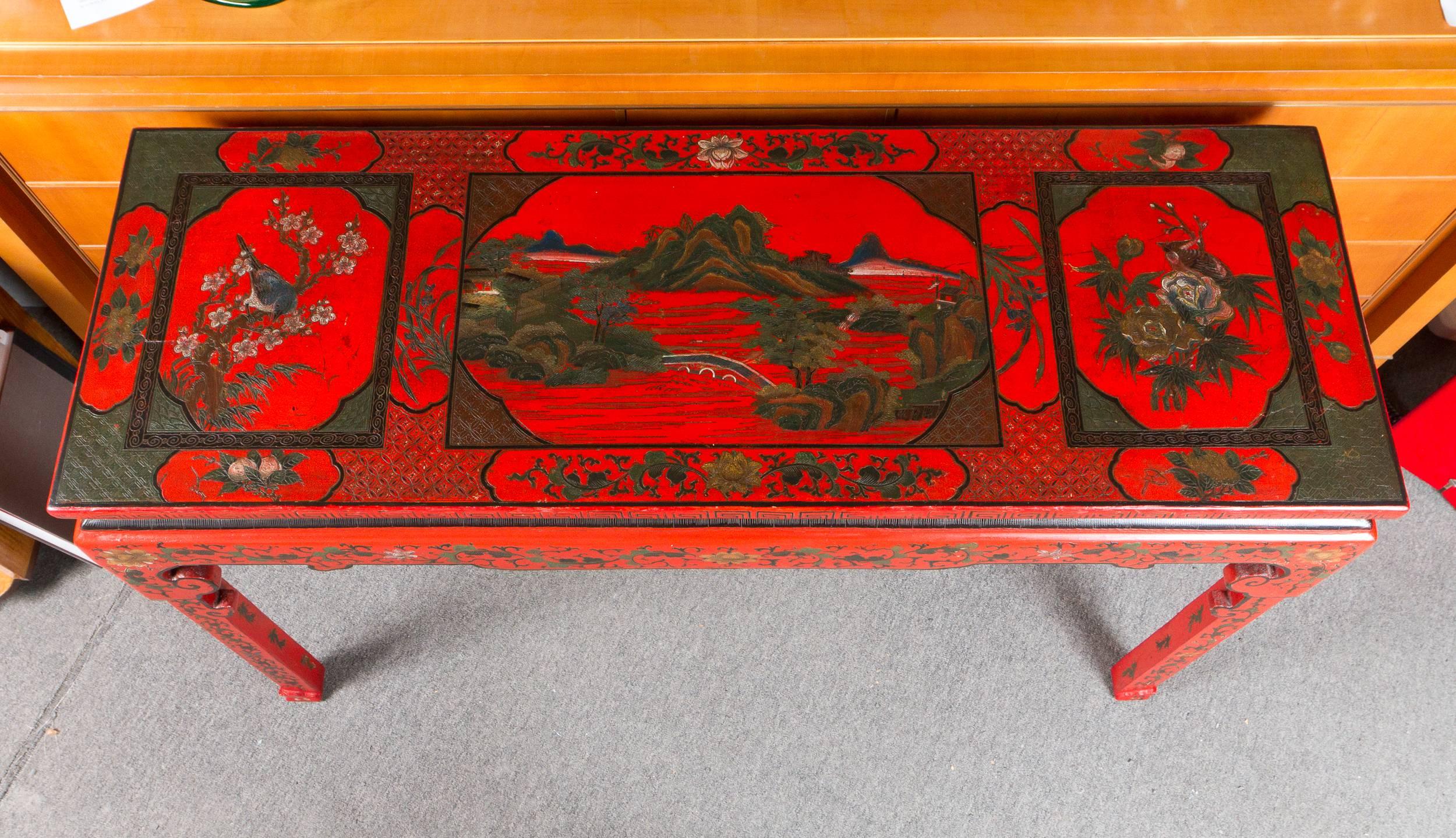 Table d'autel chinoise en laque cinabre rouge vibrante, le plateau présentant un cartouche représentant un paysage chinois.