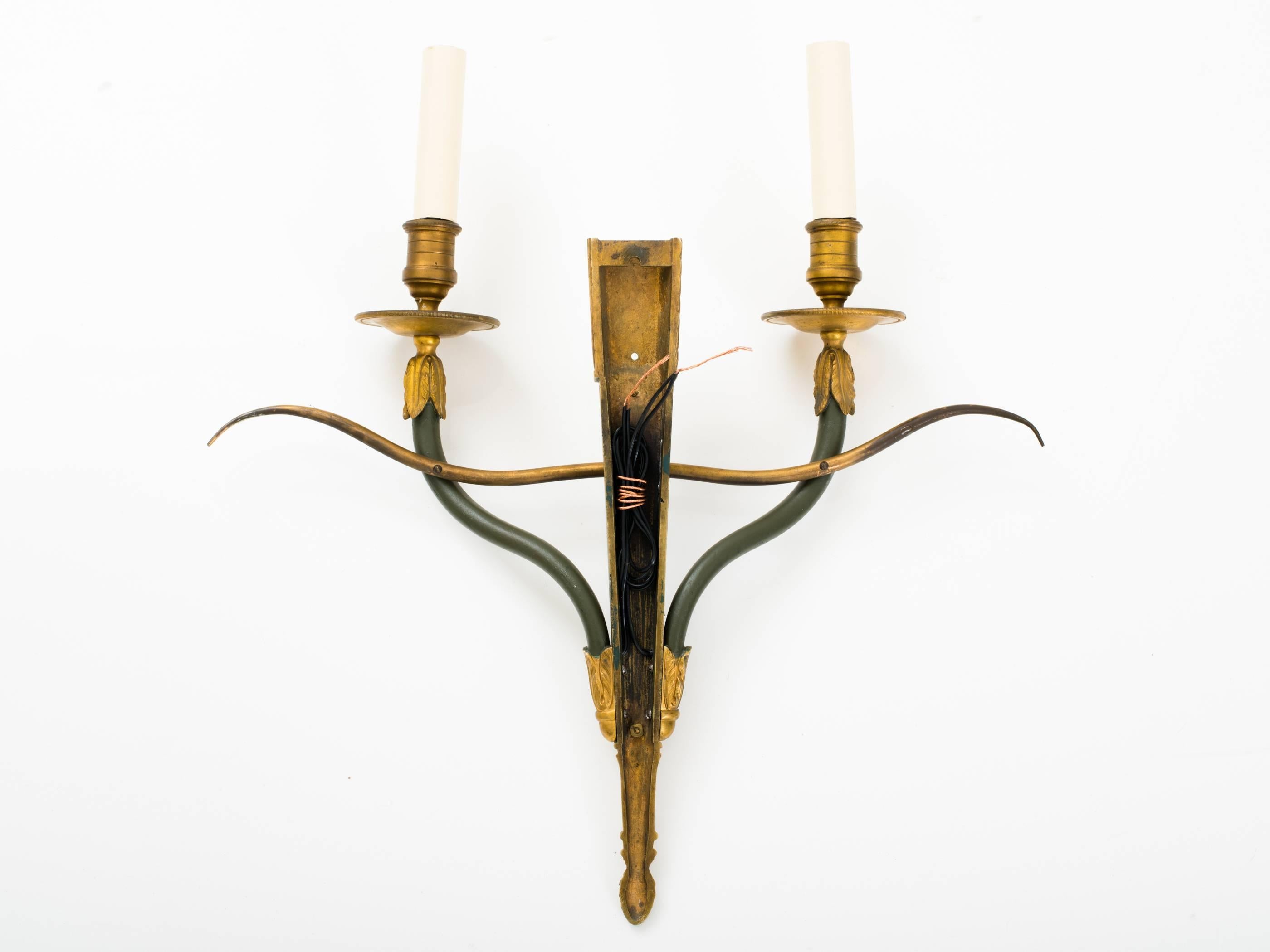 Elegant pair of directoire style gilt and patinated bronze sconces with 