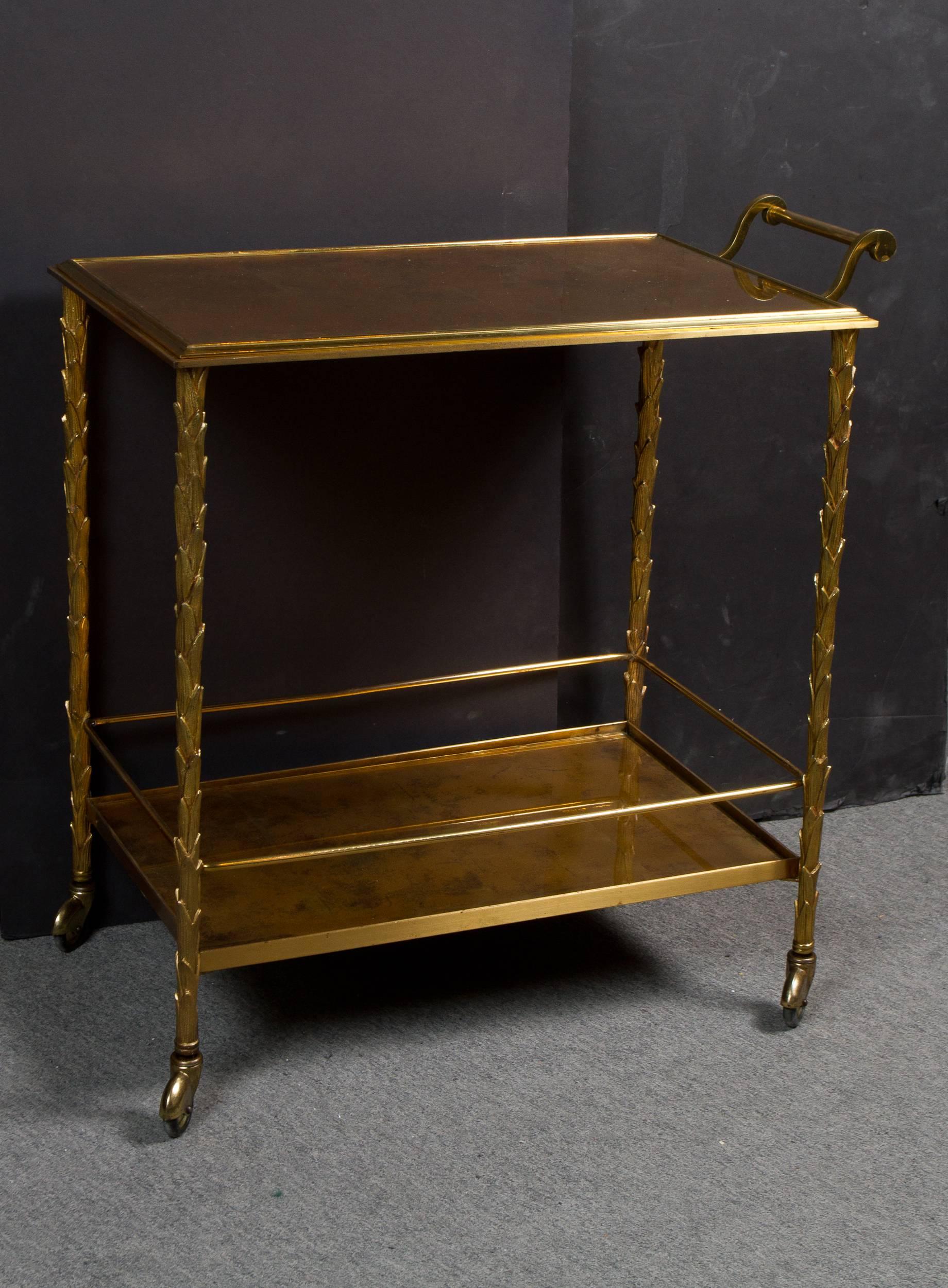 Gilt bronze two-tier bar cart by Maison Baguès. Fitted with original églomisé glass top.



  
 