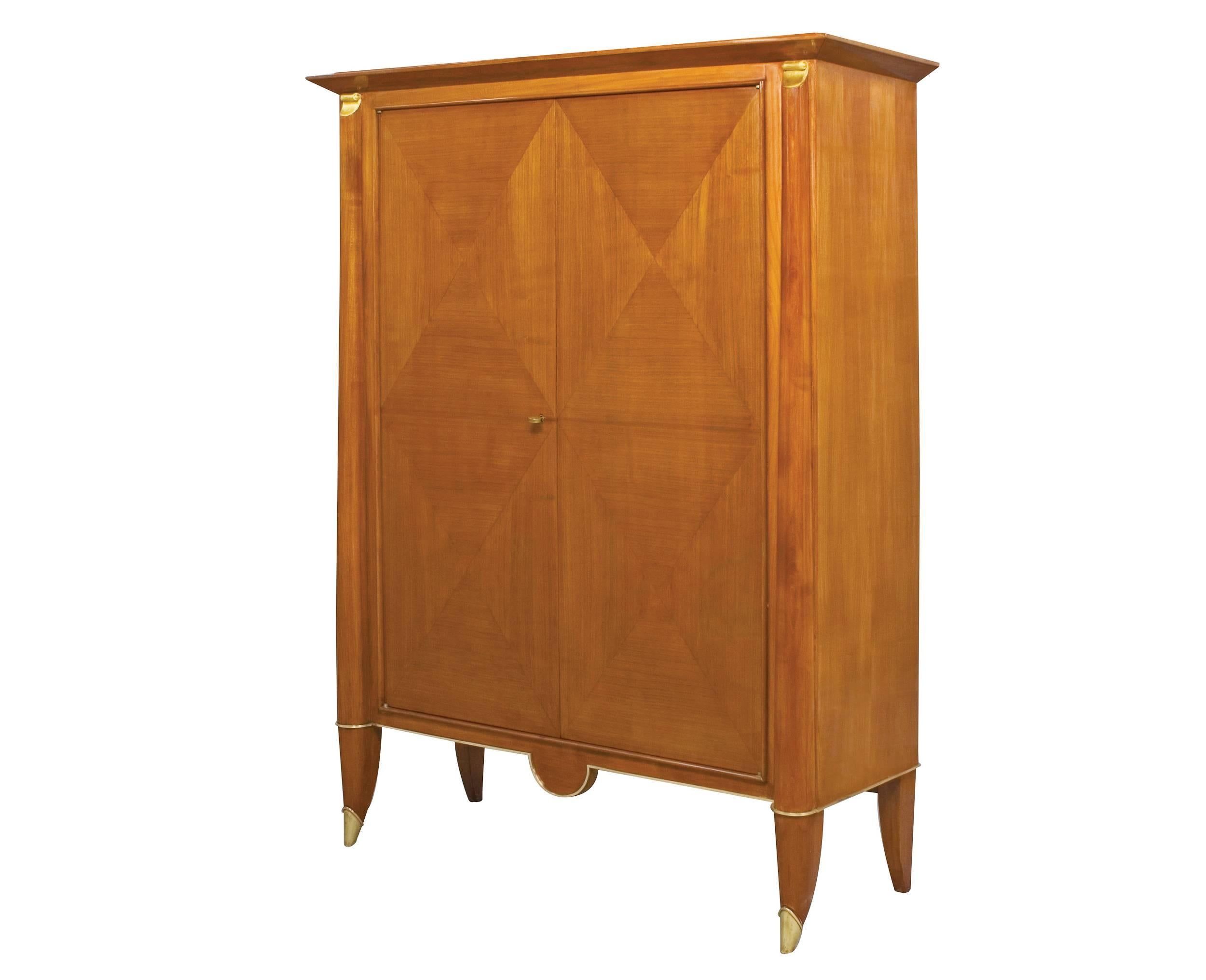 Elegant cherrywood Art Deco cabinet in the manner of André Arbus, the doors featuring a veneered geometric design, the base fitted with gilt bronze mounts.
France, circa 1940.