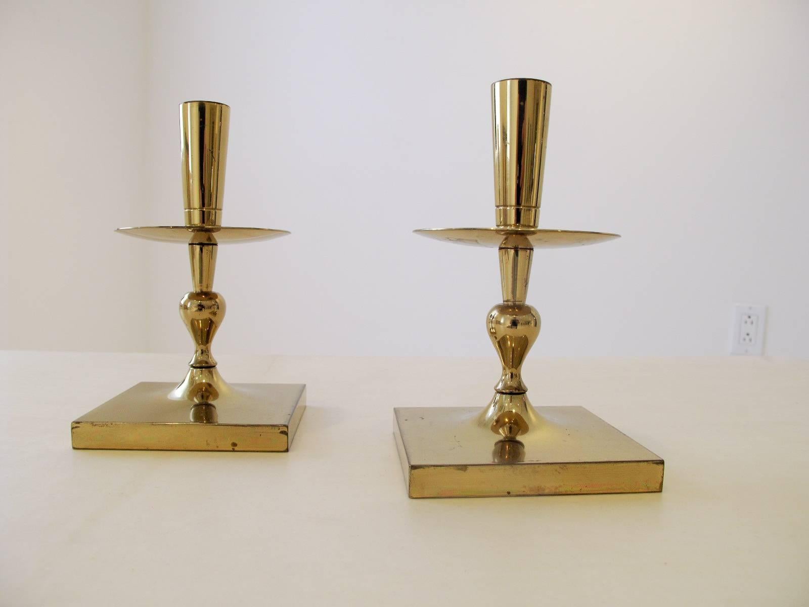 Great pair of Tommi Parzinger design solid brass candle sticks .