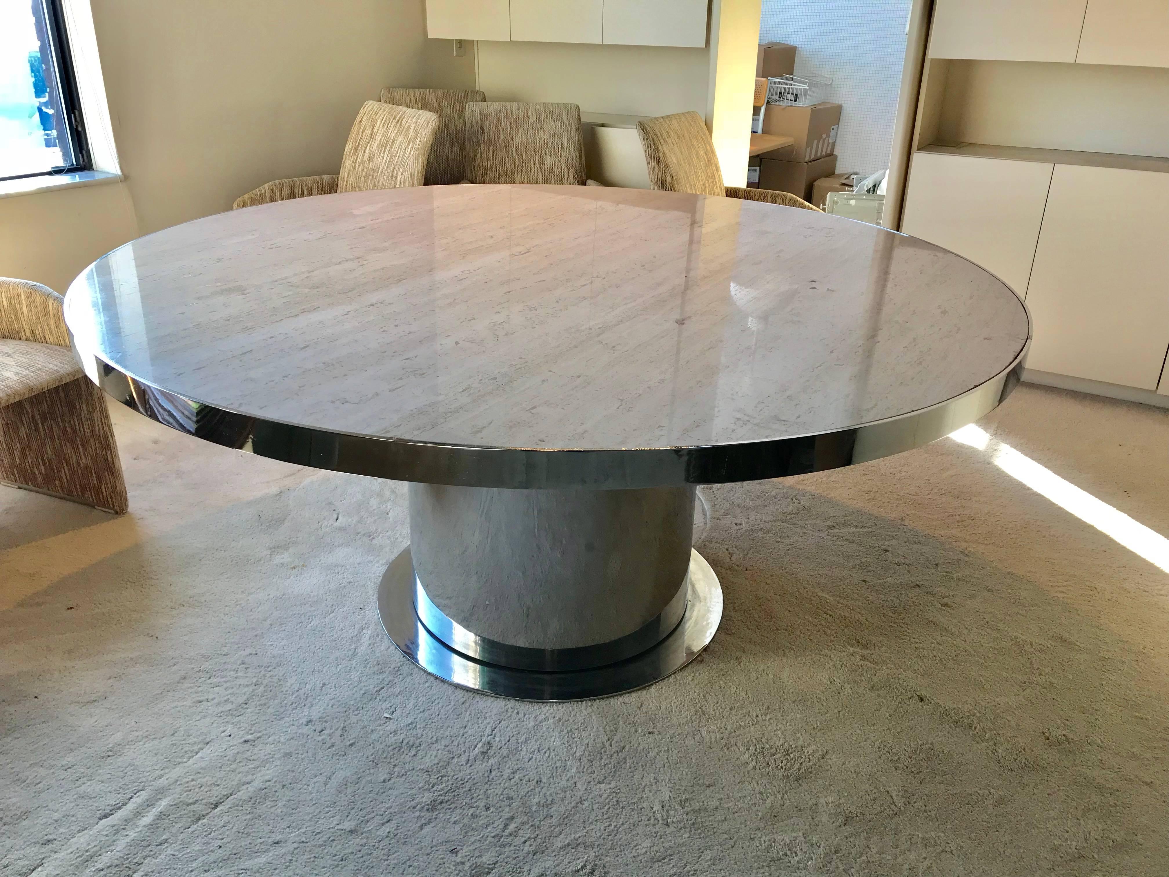 Italian modernist circular travertine top and chrome dining table.