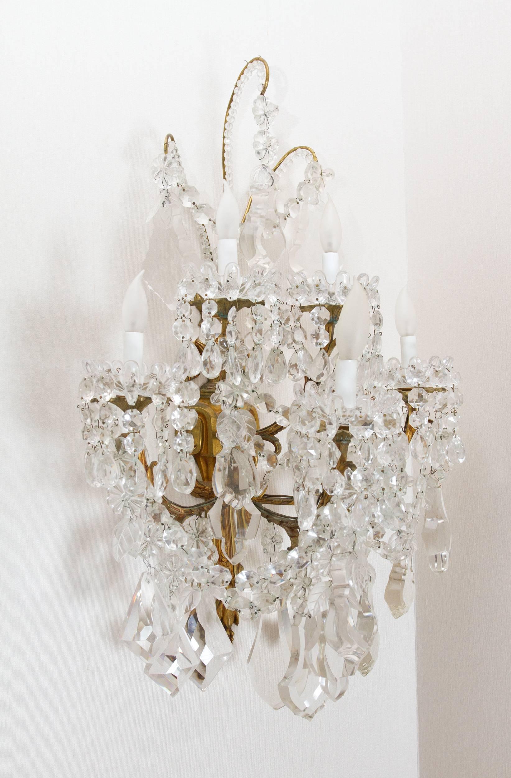 Stunning and large pair of neoclassical style crystal and gilt bronze sconces by Baccarat. Signed 